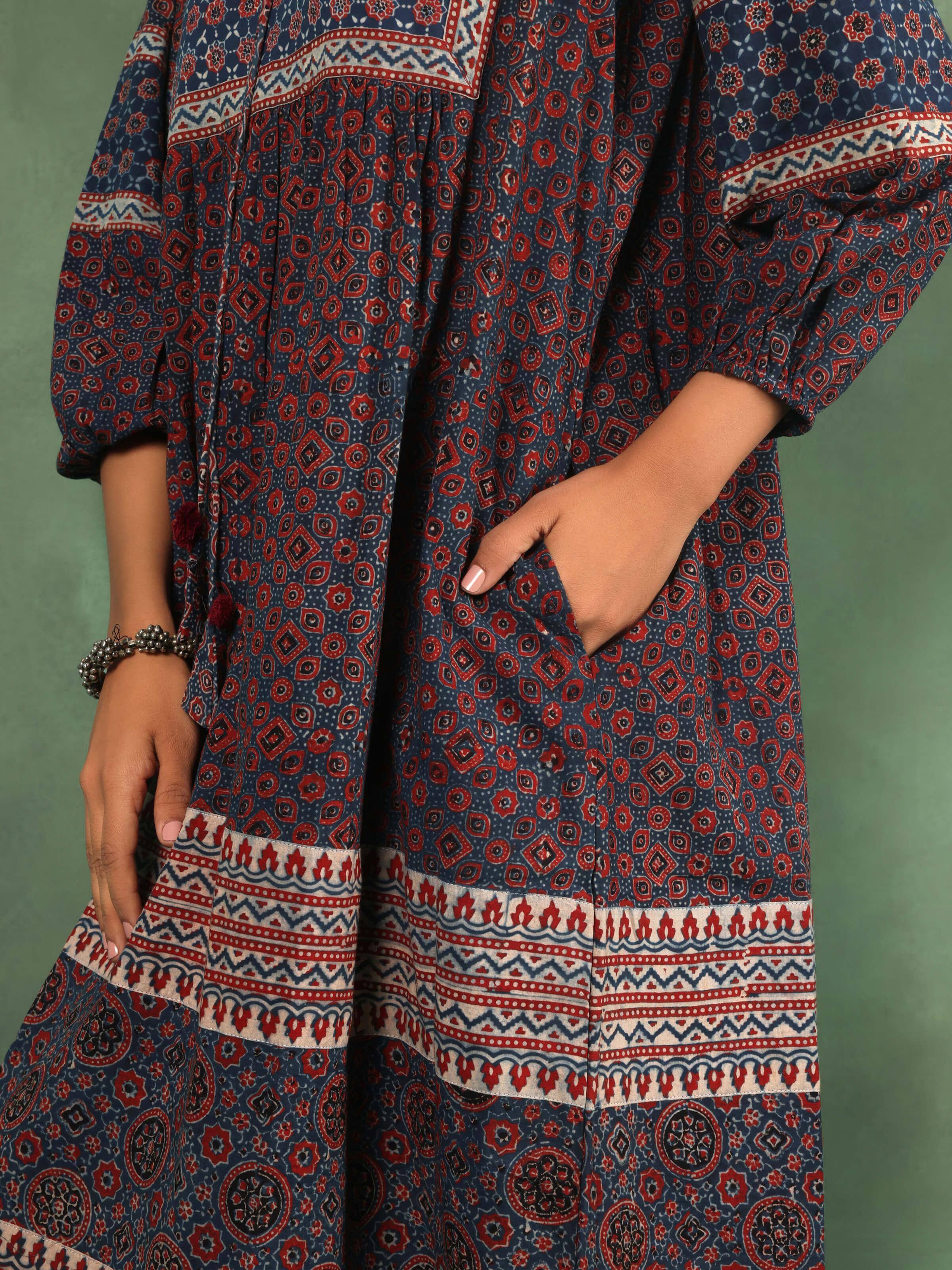 Detail view showing neckline, print, and soft gathers of summer dress