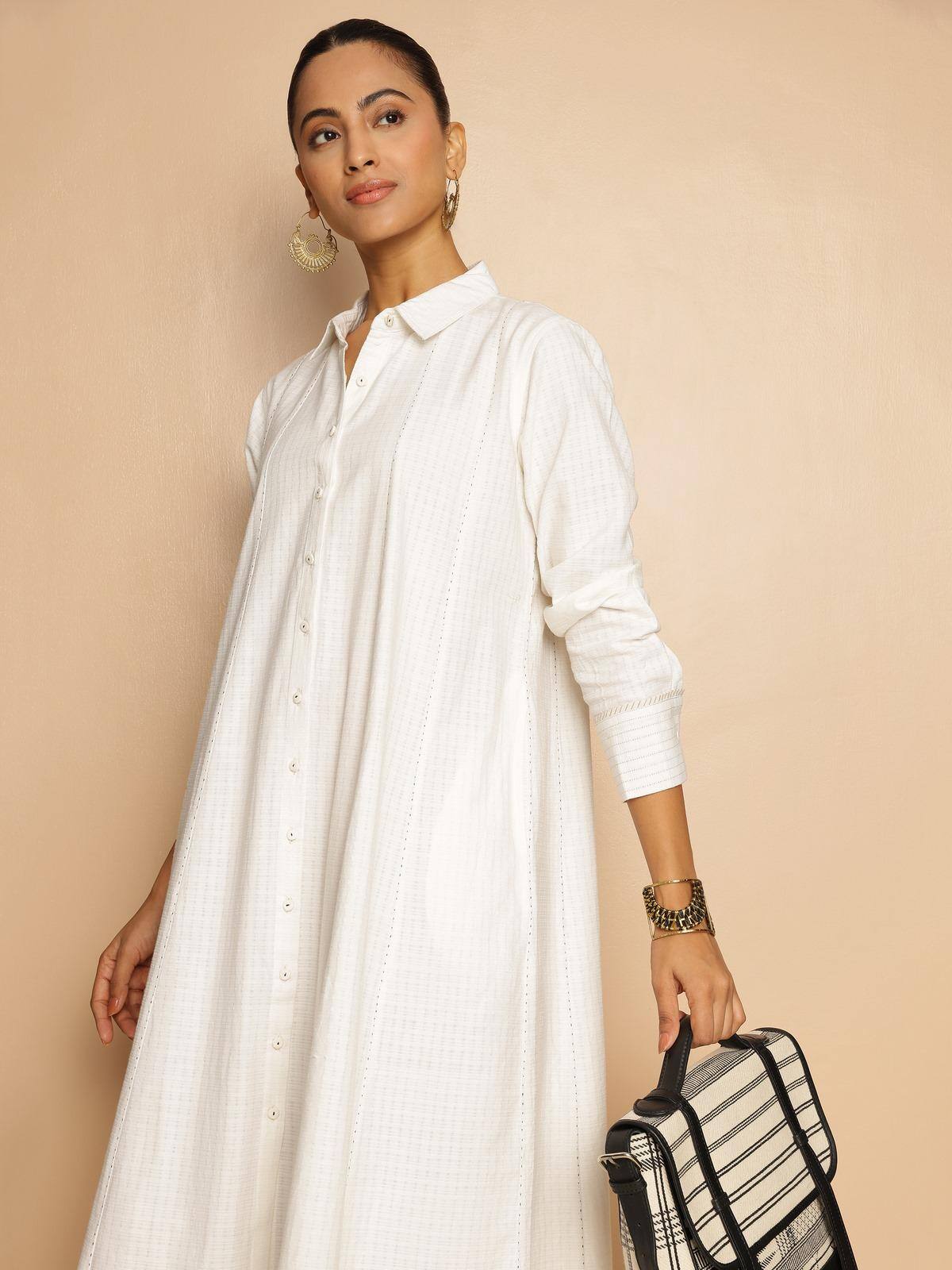 Angled lifestyle view highlighting panelled design and crisp cotton texture of dress