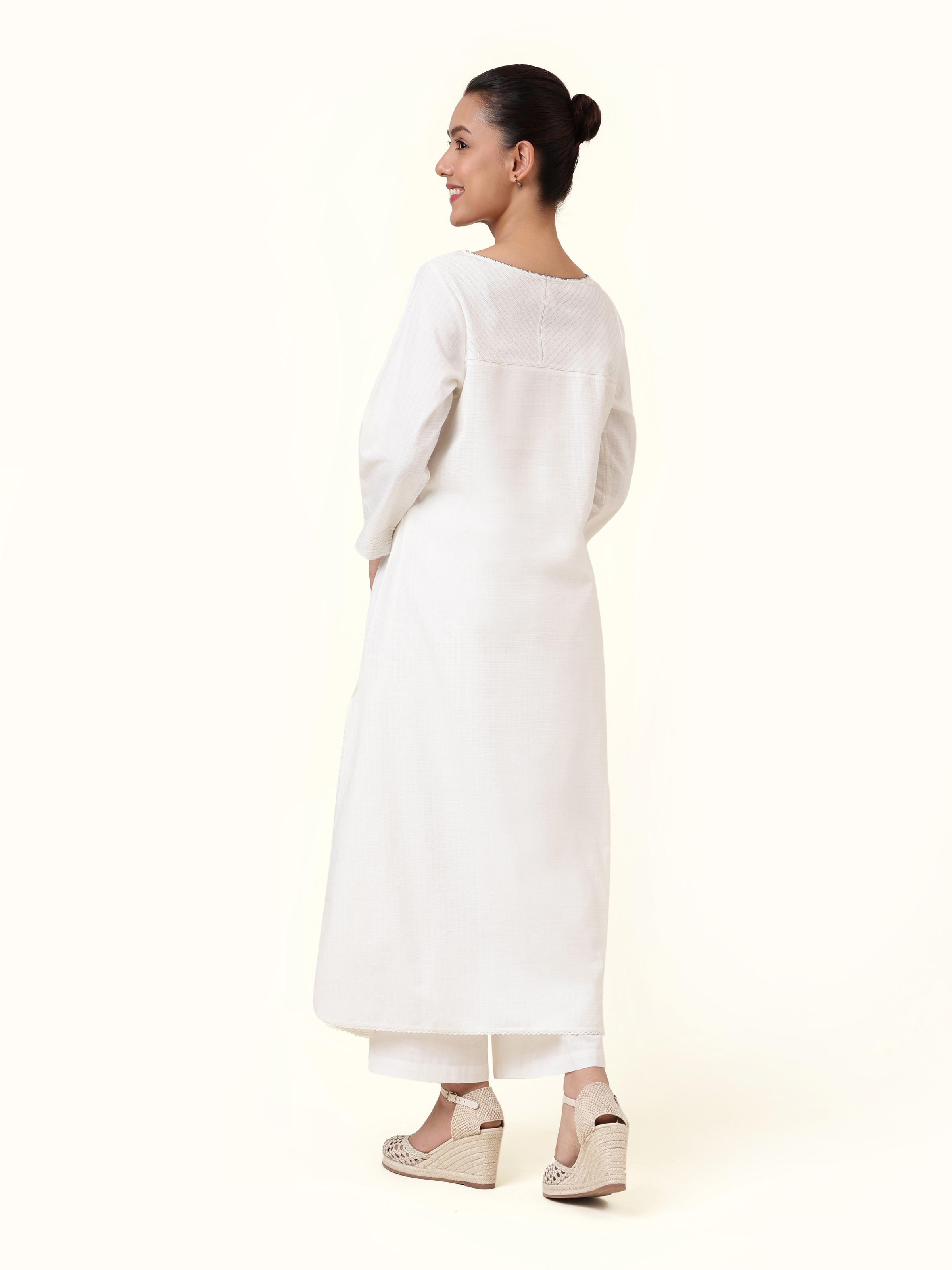 Back view of off-white cotton kurta highlighting back slit and yoke