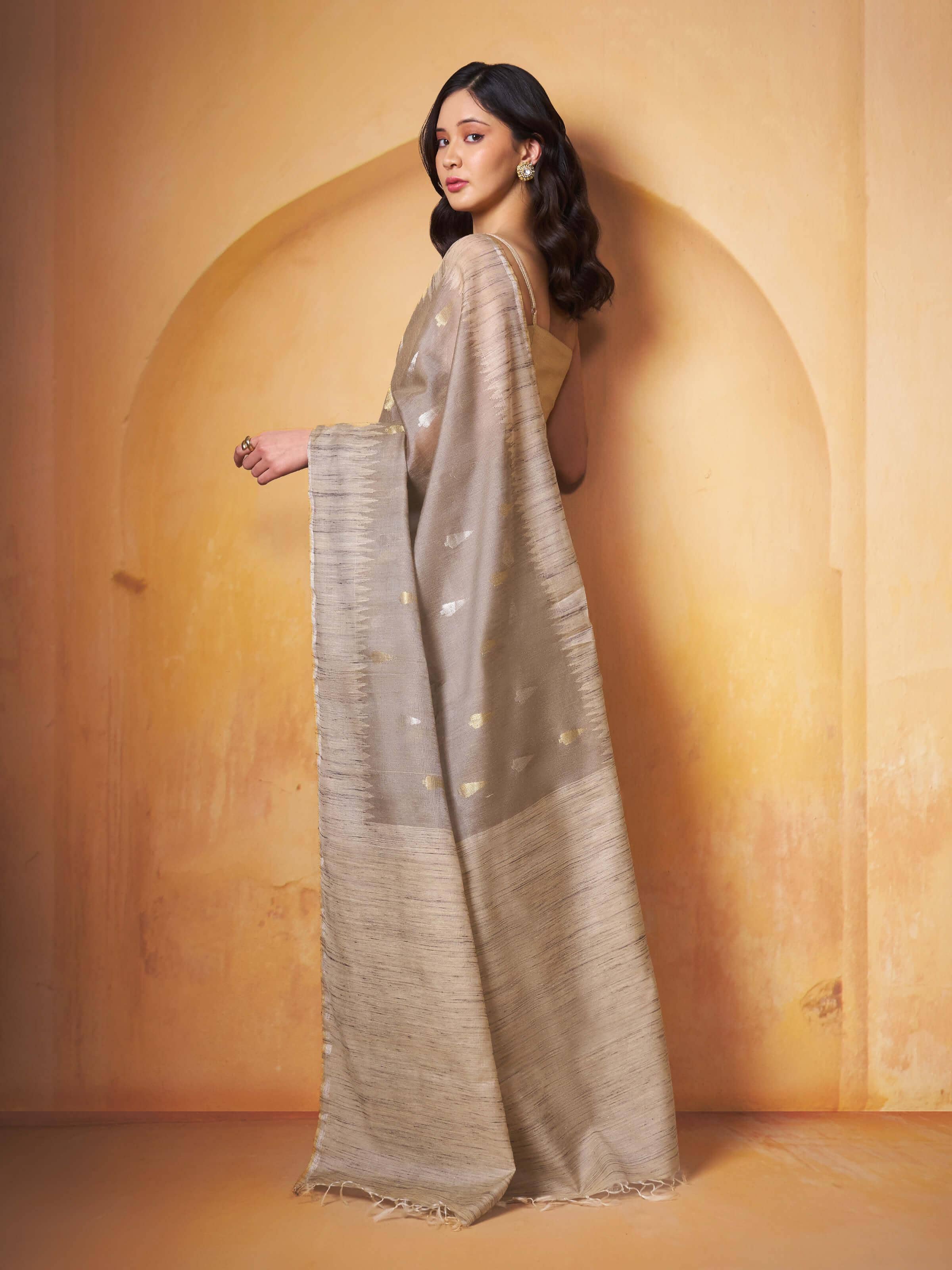 Angled view showing flowing fabric and delicate texture of tussar silk saree