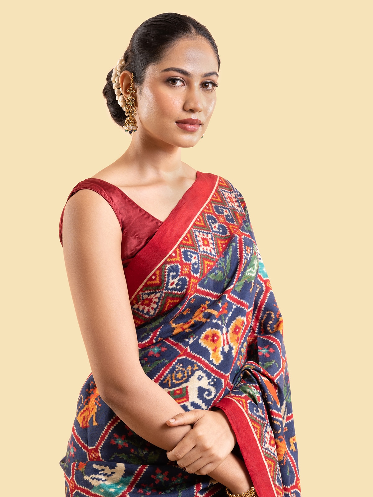Close-up of navy blue mulberry silk patan patola saree focusing on detailed embroidery and fabric sheen