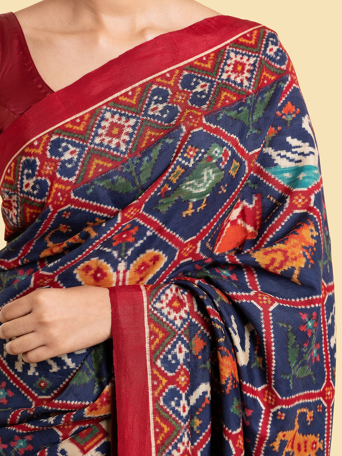 Angled view of navy blue mulberry silk patan patola saree highlighting overall elegance and drape