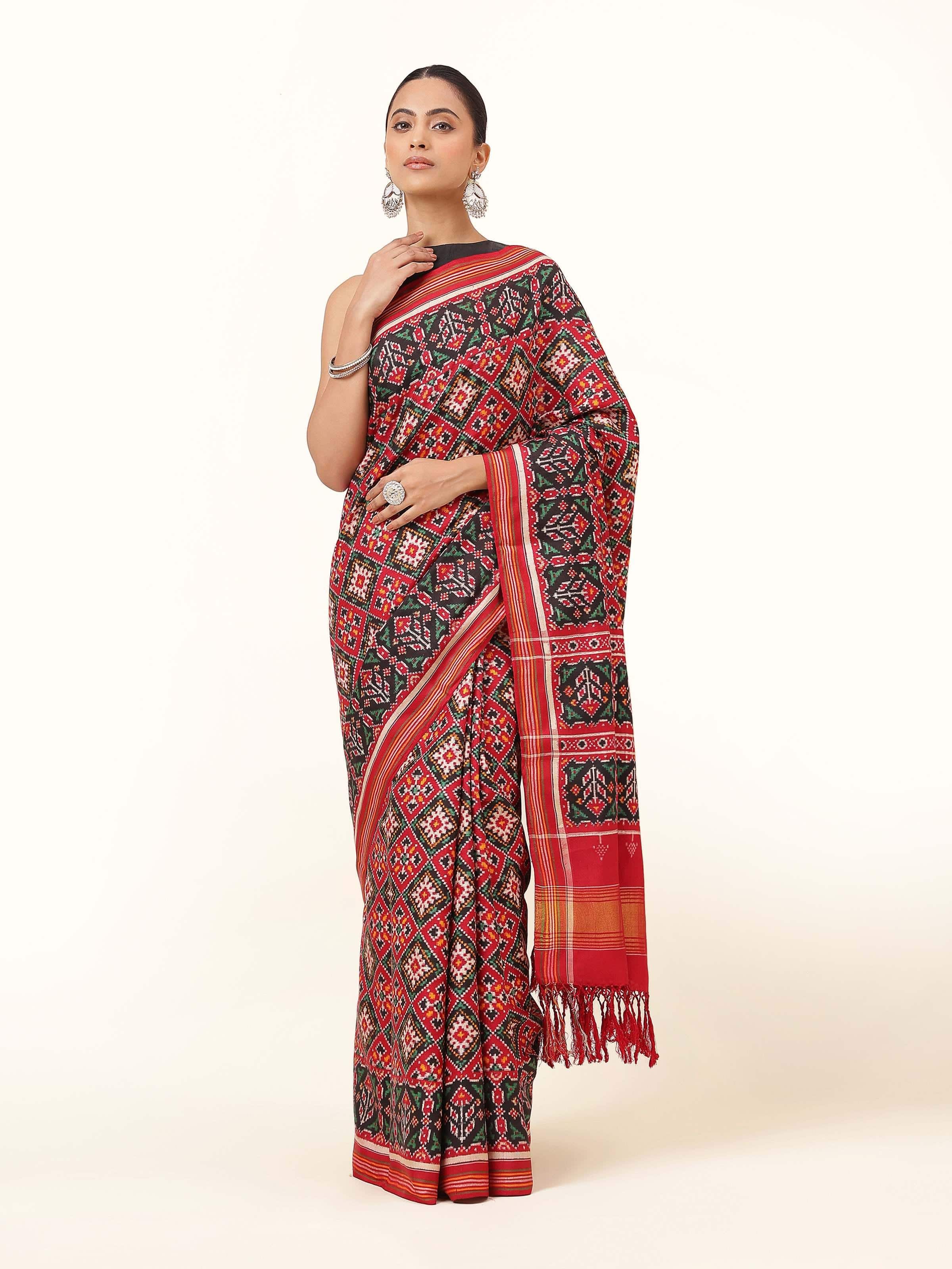 Front view of Red & Green Mulberry Silk Patan Patola Saree featuring vibrant red and green silk with Patola weaving patterns.