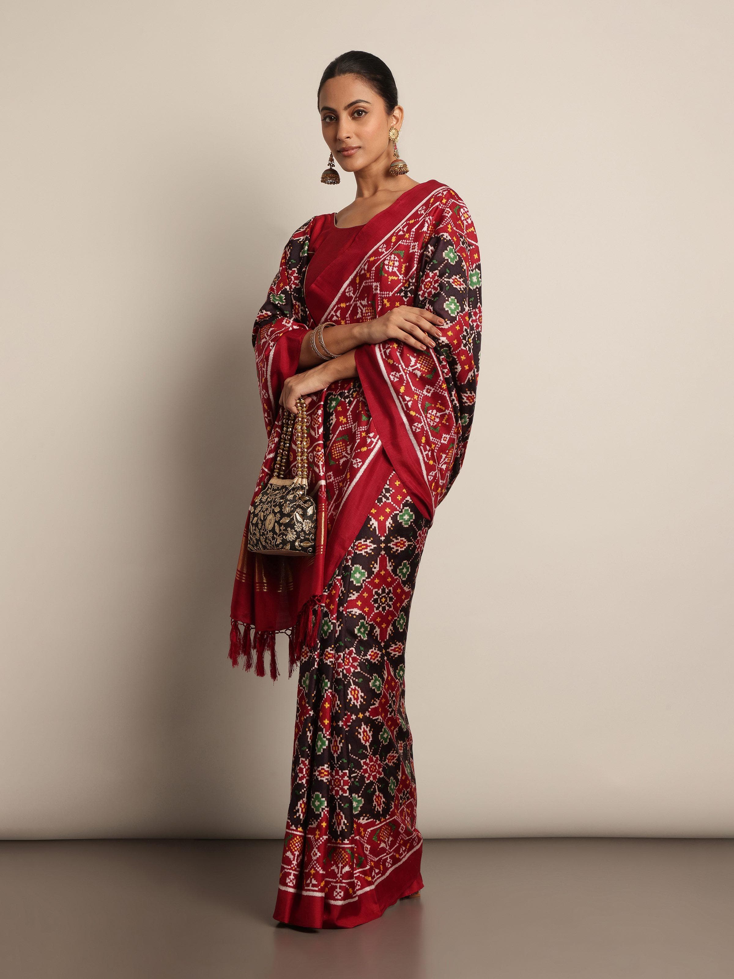 Lifestyle image of Black Mulberry Silk Patan Patola Saree worn traditionally