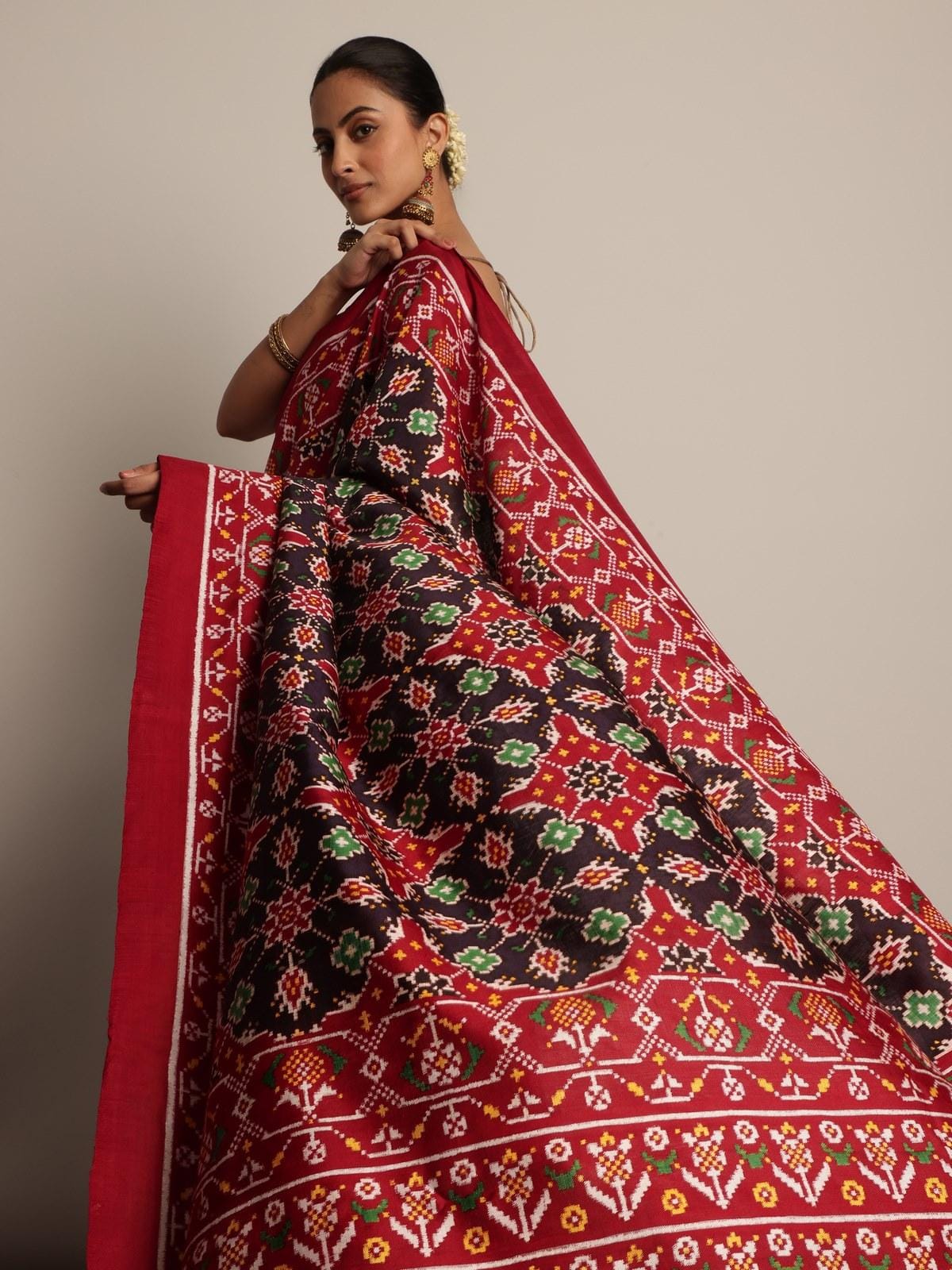 Detailed close-up of intricate Patan Patola silk weaving and vibrant colors