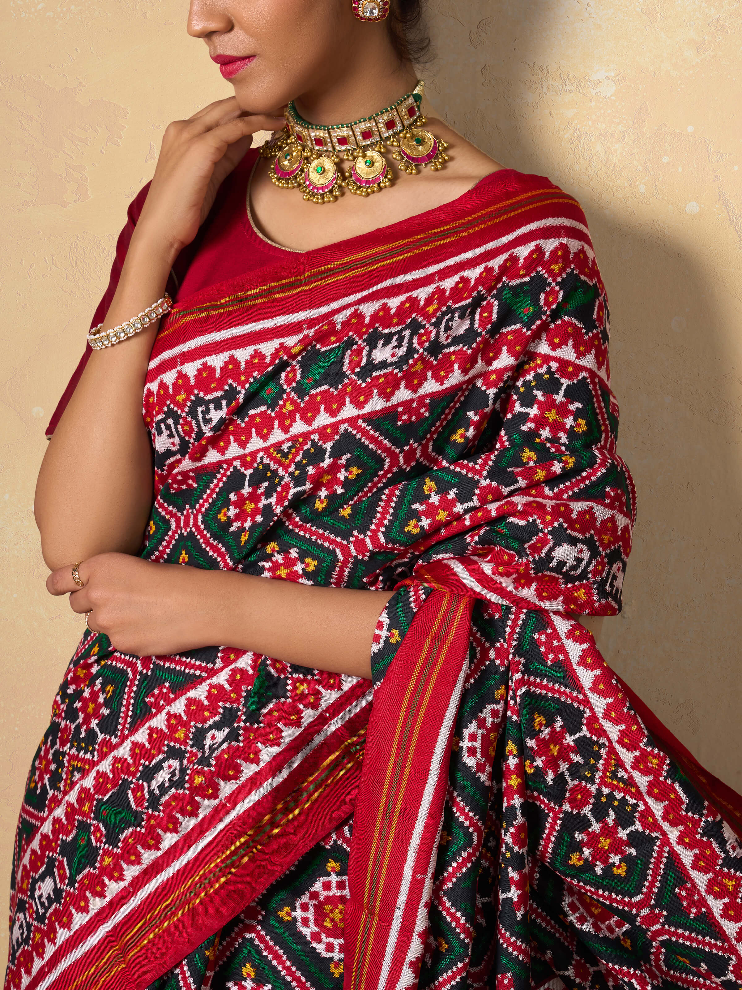 Red mulberry silk Patan Patola saree detail shot capturing fine weaving details and border design