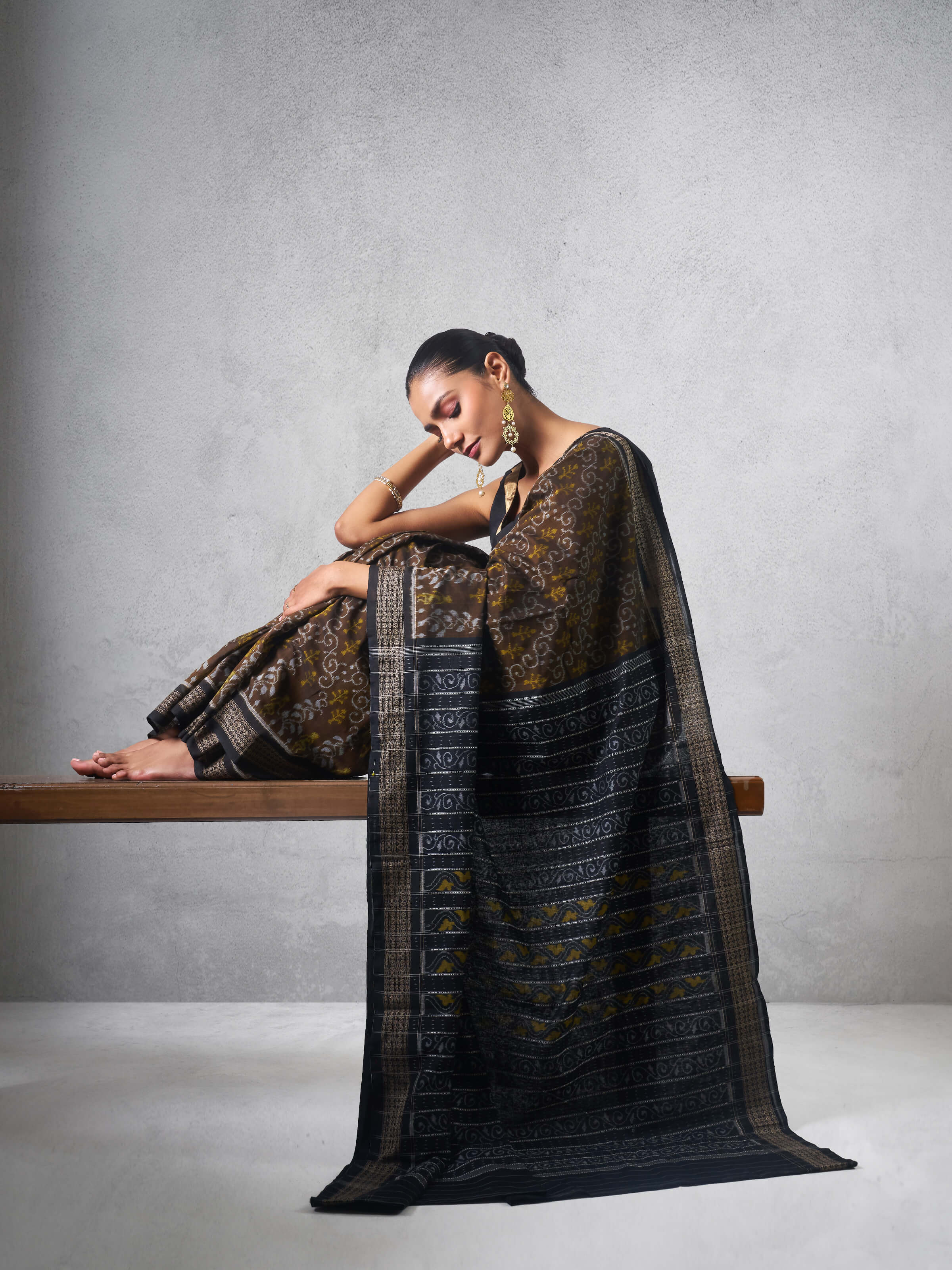 Angled view of Brown Cotton Bandha Odisha Ikat Saree showing cotton fabric and weaving details