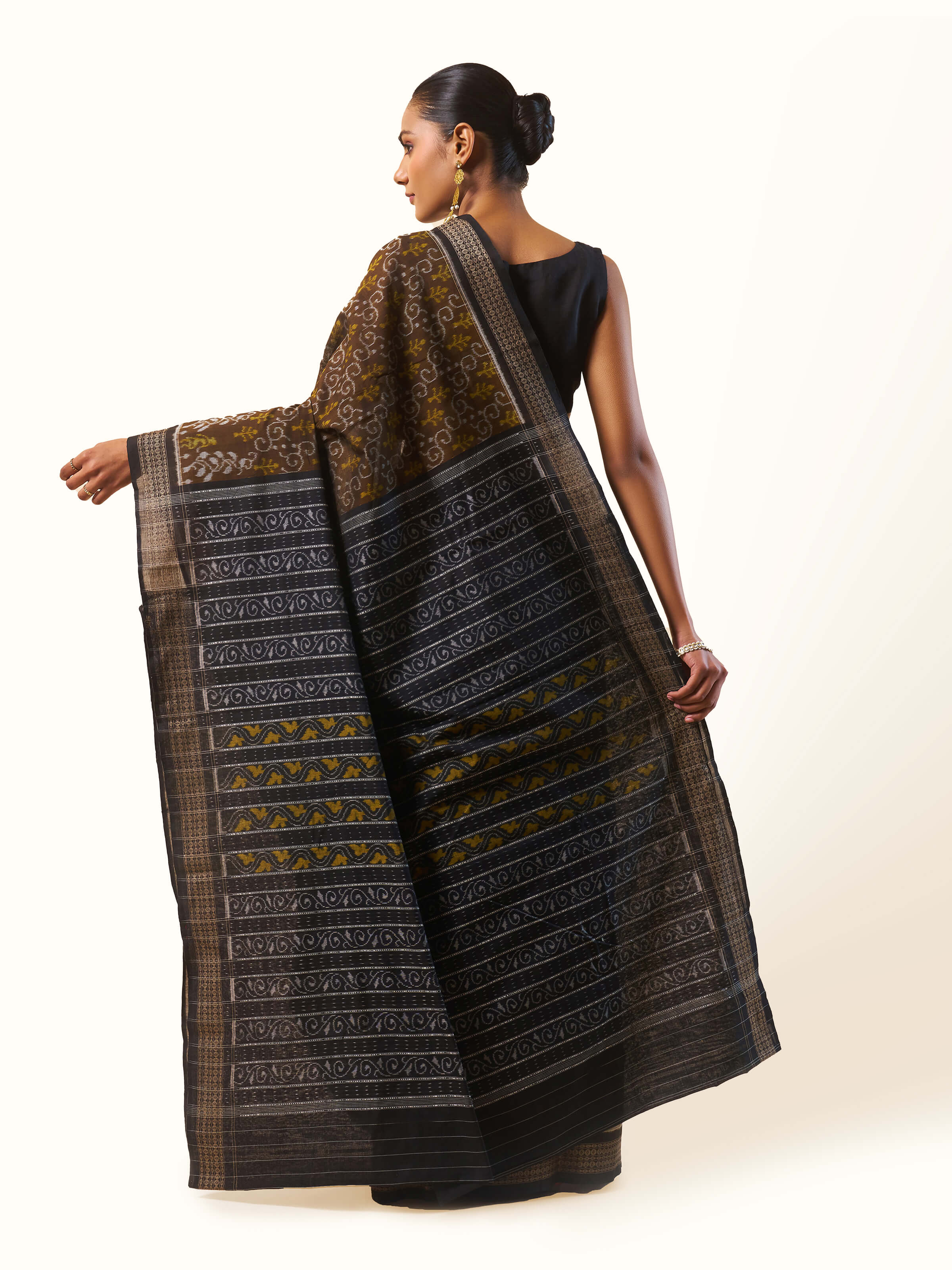 Back view of Brown Cotton Bandha Odisha Ikat Saree displaying full pattern and fabric texture