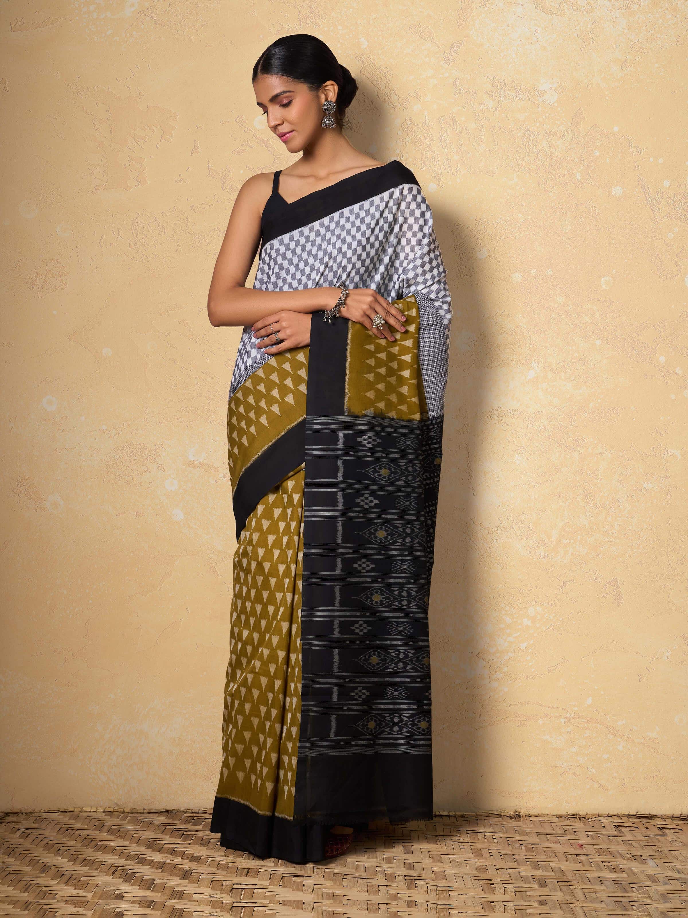 Lifestyle shot of model wearing Mustard Cotton Odisha Ikat Saree styled casually