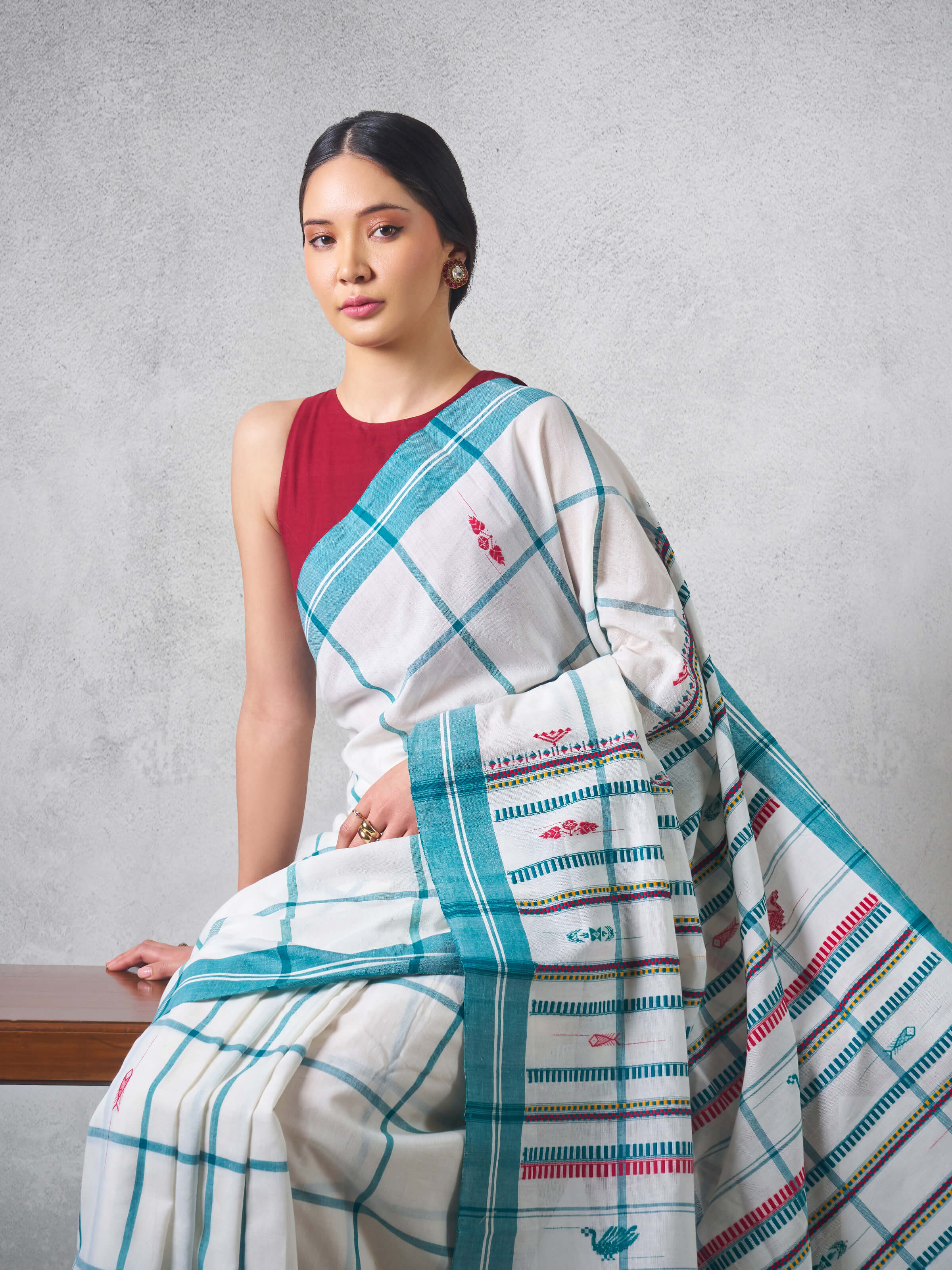 Angled view highlighting the texture and detailed weaving of blue cotton extra-weft saree.