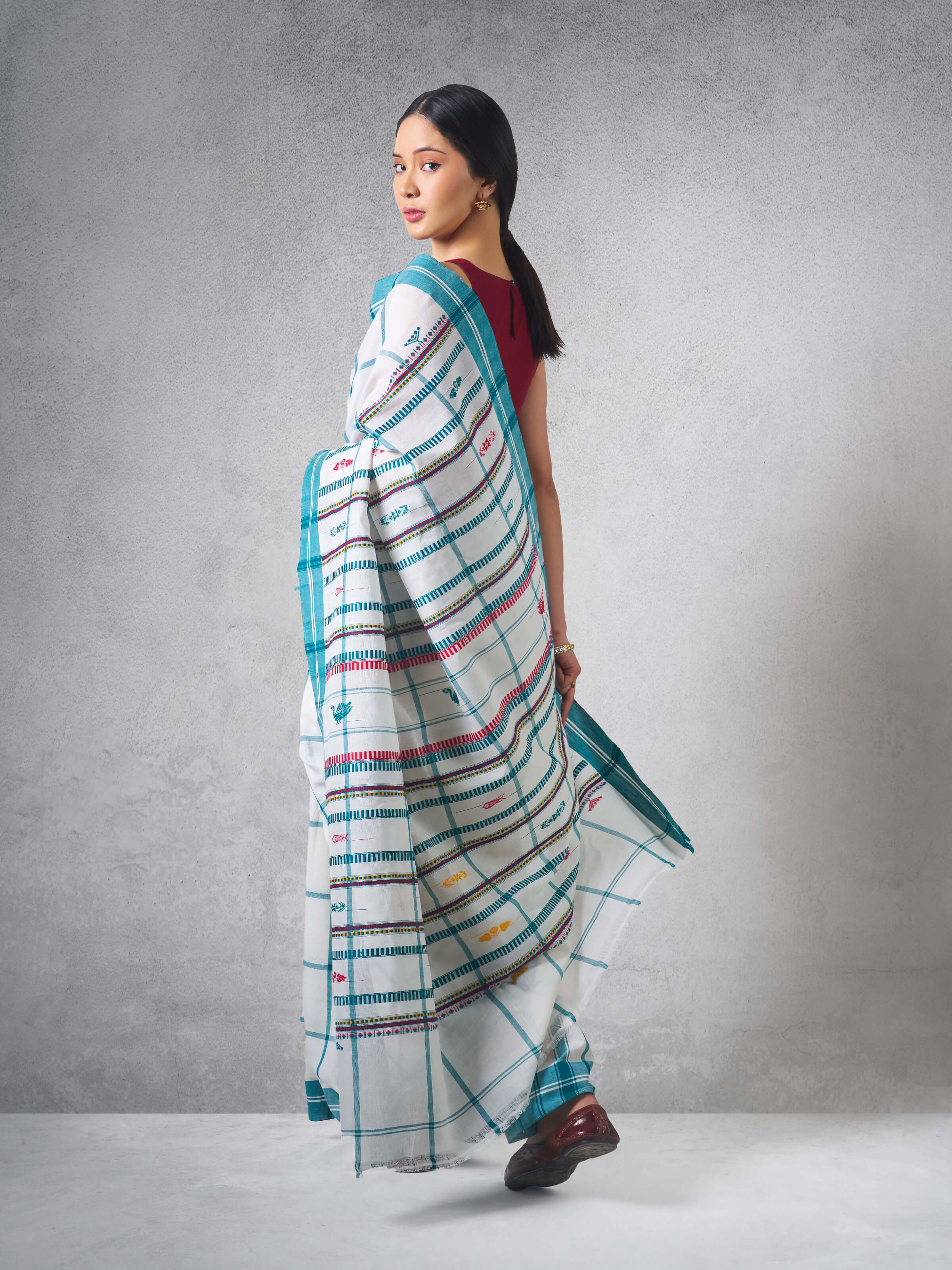 Close-up detail of fabric weave and pattern on blue cotton extra-weft saree.