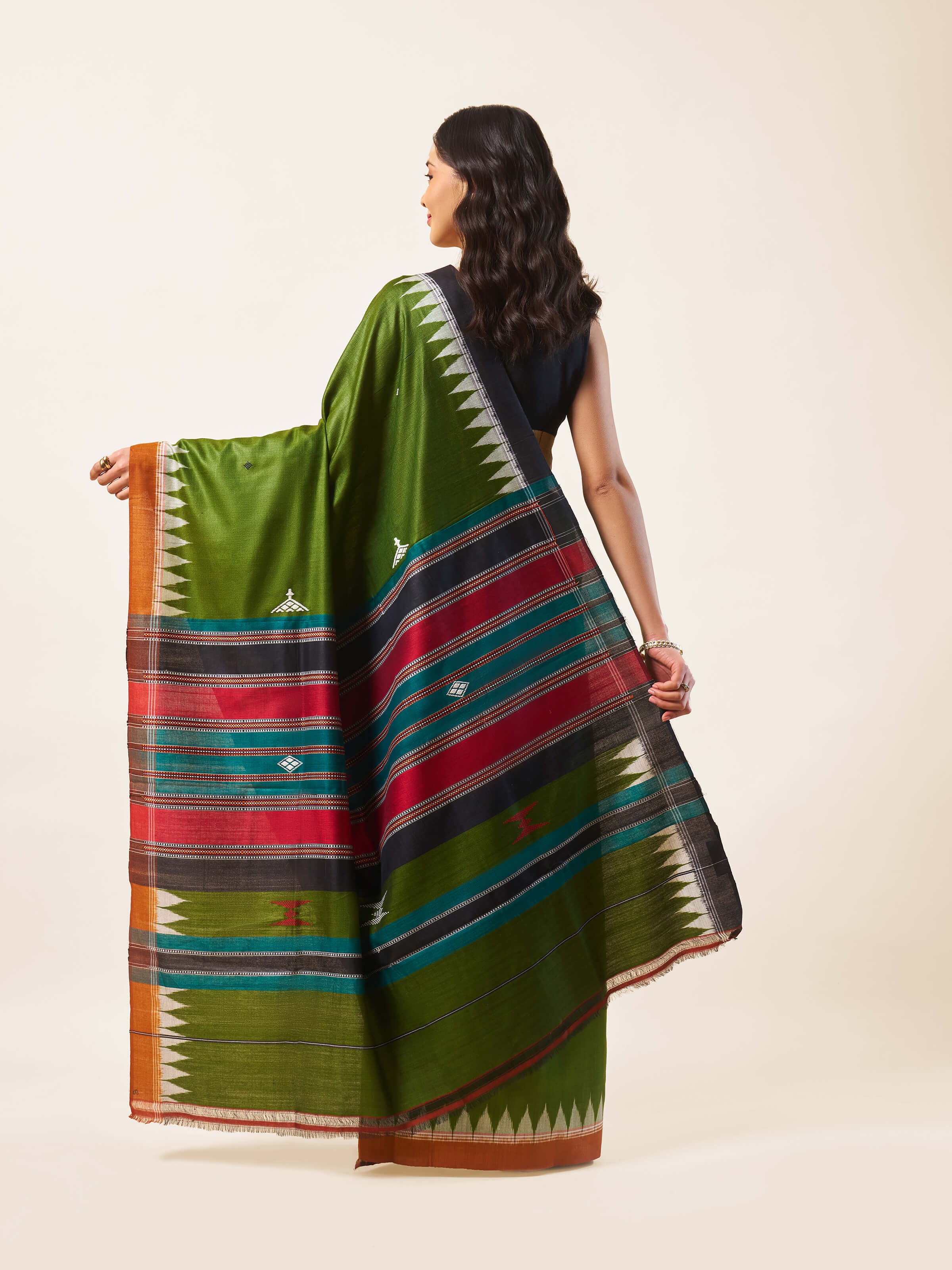 Back view revealing the pallu design of the green Odisha Ikat saree.