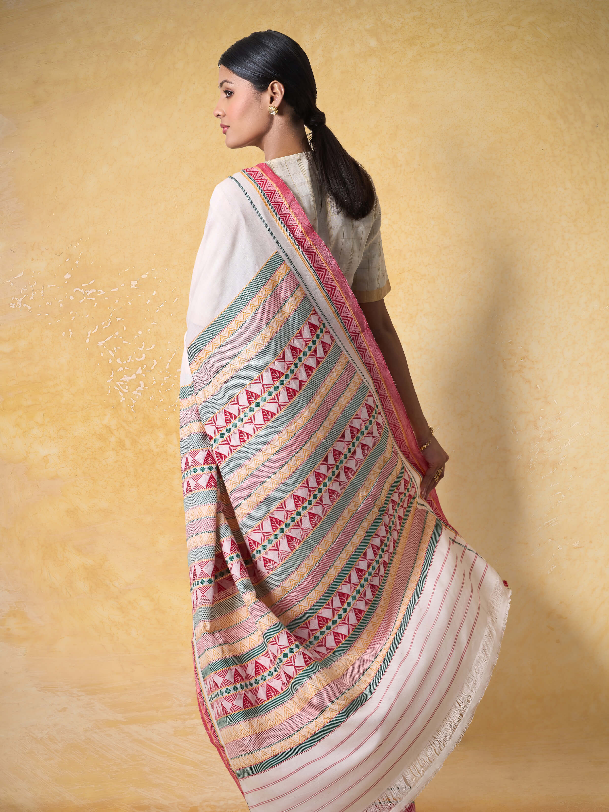 Angled view highlighting texture and weave of Dongaria cotton saree.