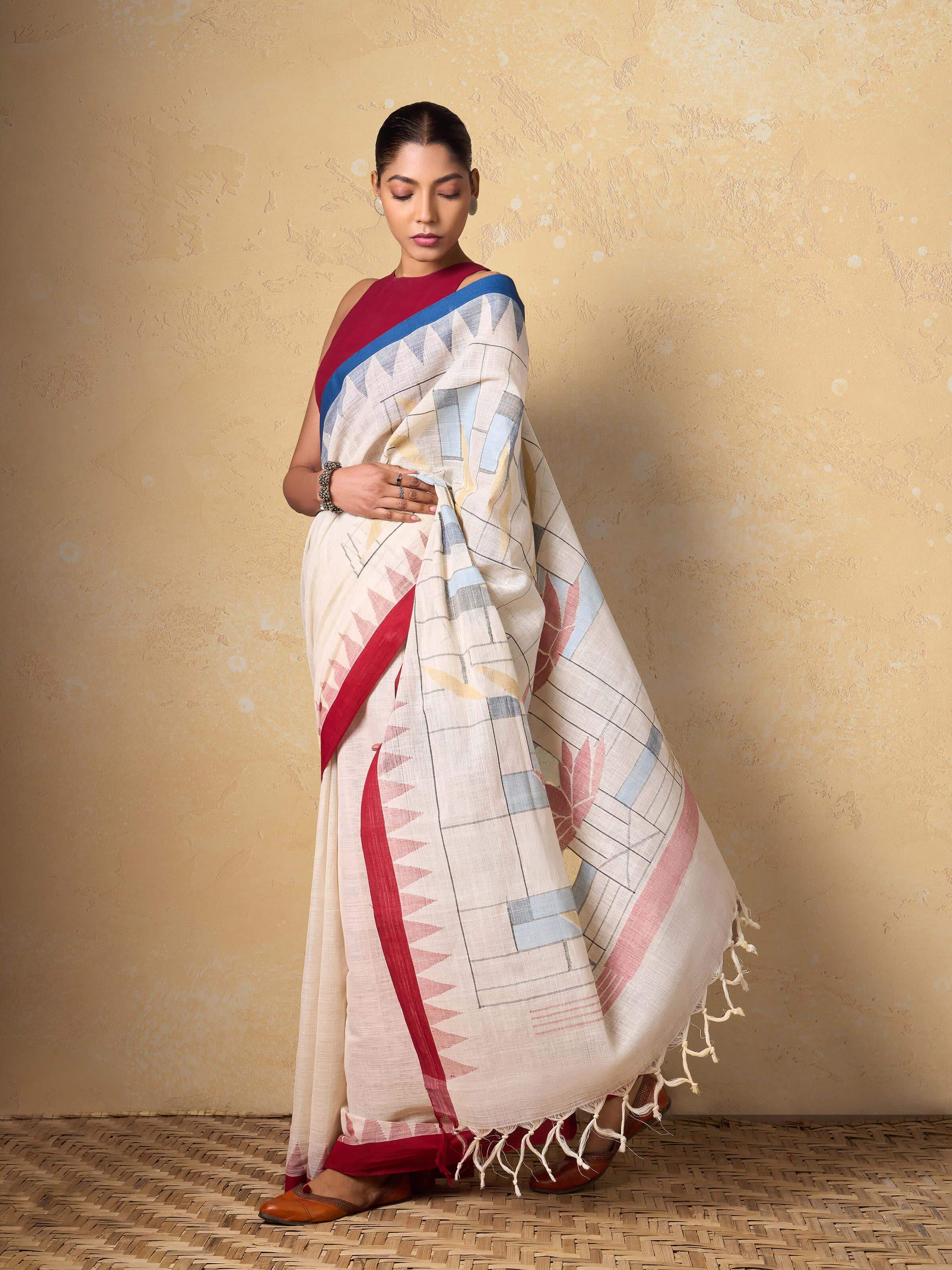 Model draped in off-white Jamdani cotton saree showcasing the elegant fall and minimal woven details.