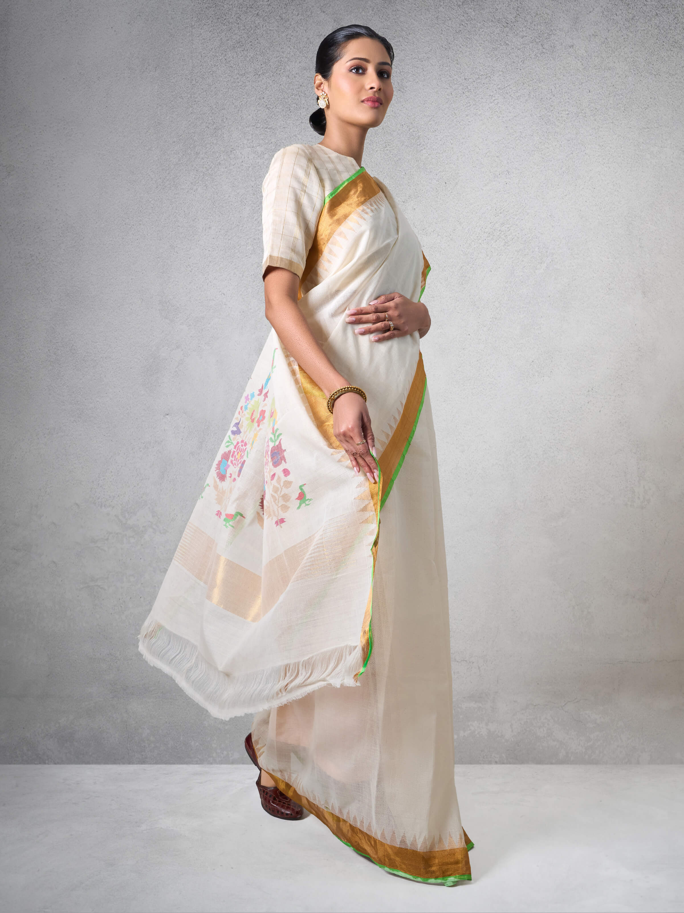 Model wearing off-white Uppada Jamdani saree showing its elegant fall and traditional design