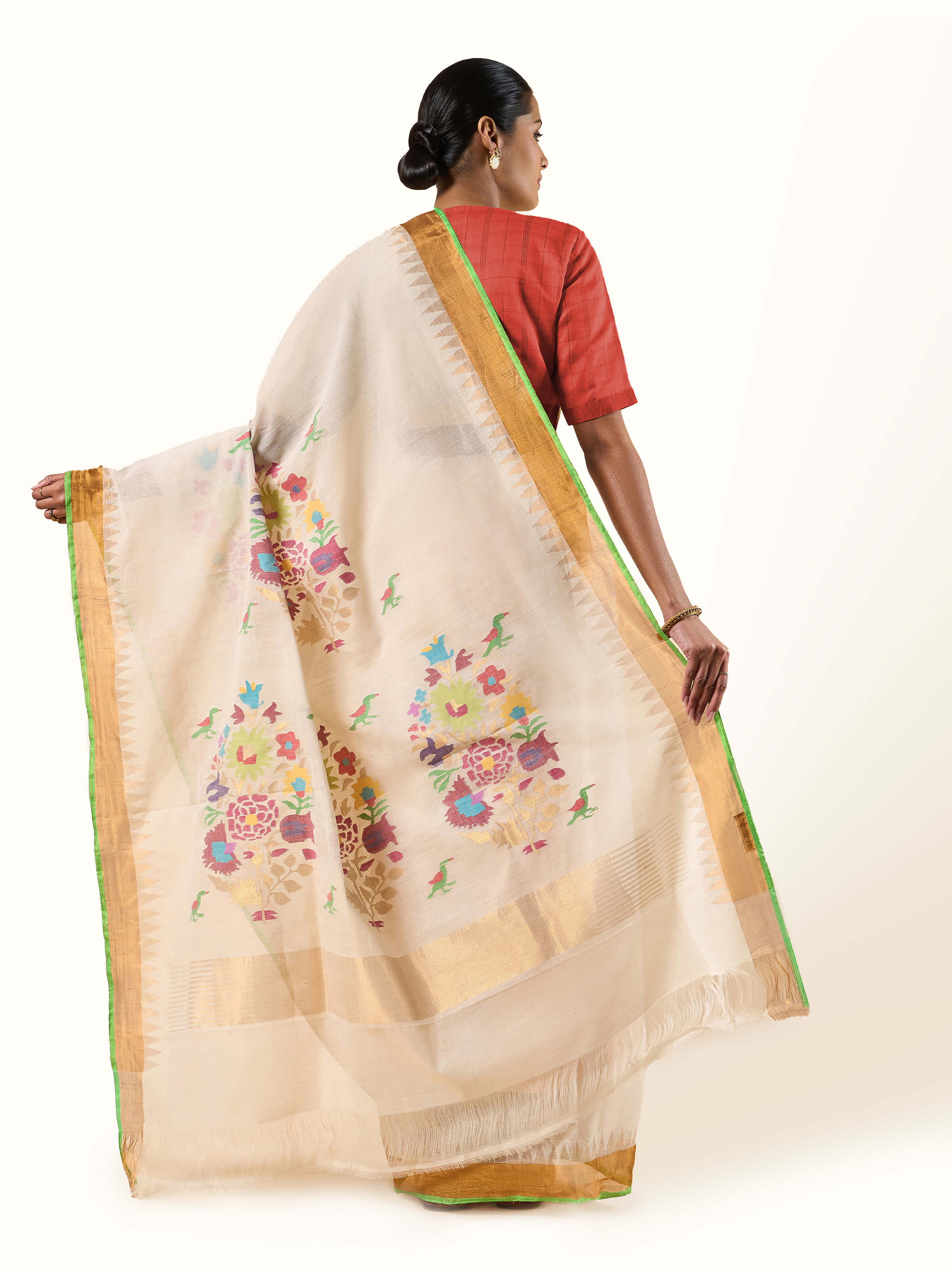 Back view of the off-white Uppada Jamdani saree with traditional patterns and soft pleats.