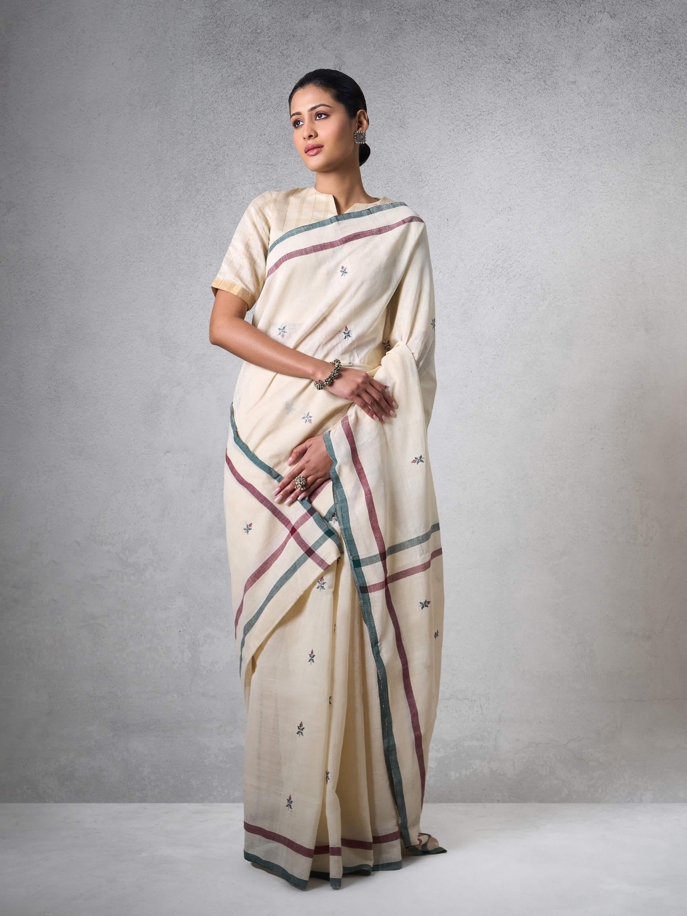 Model wearing off-white cotton Uppada saree in graceful pose