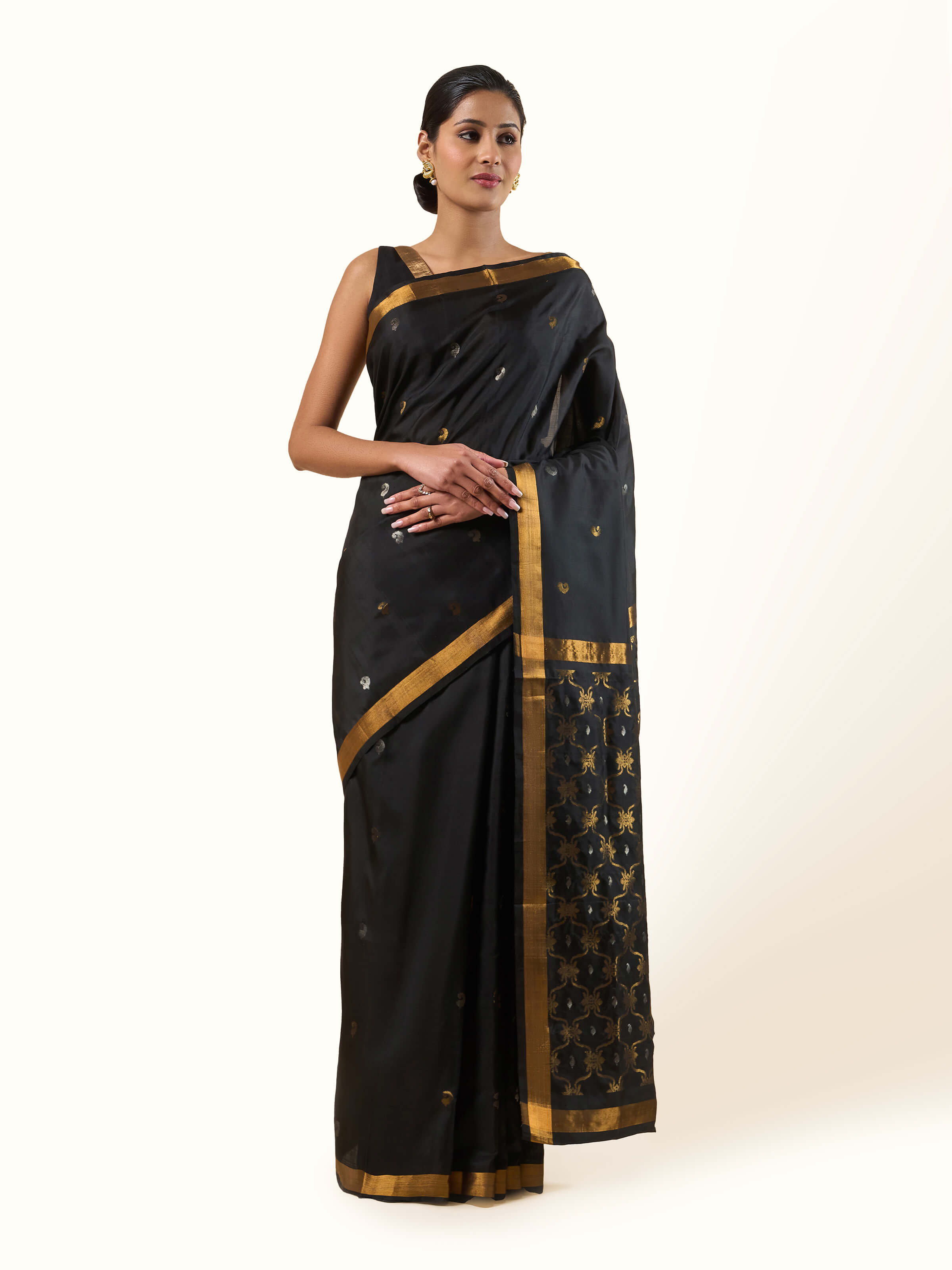 Front view of black mulberry silk Uppada Jamdani saree with golden motifs and rich sheen
