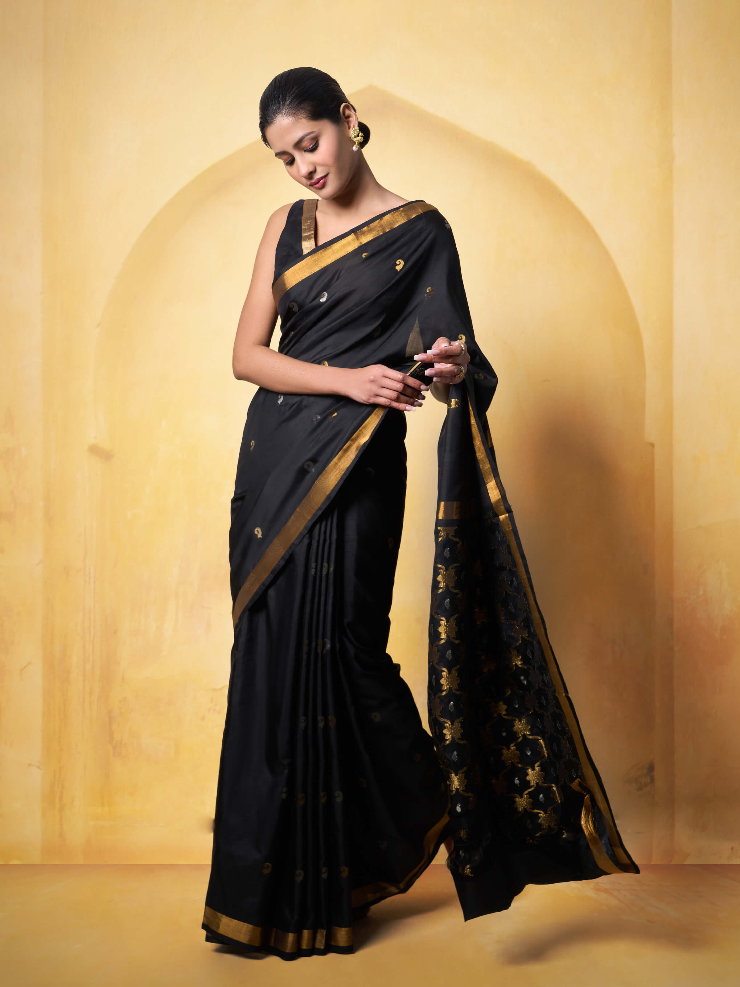 Lifestyle view of black Uppada Jamdani saree draped elegantly with a contrasting blouse