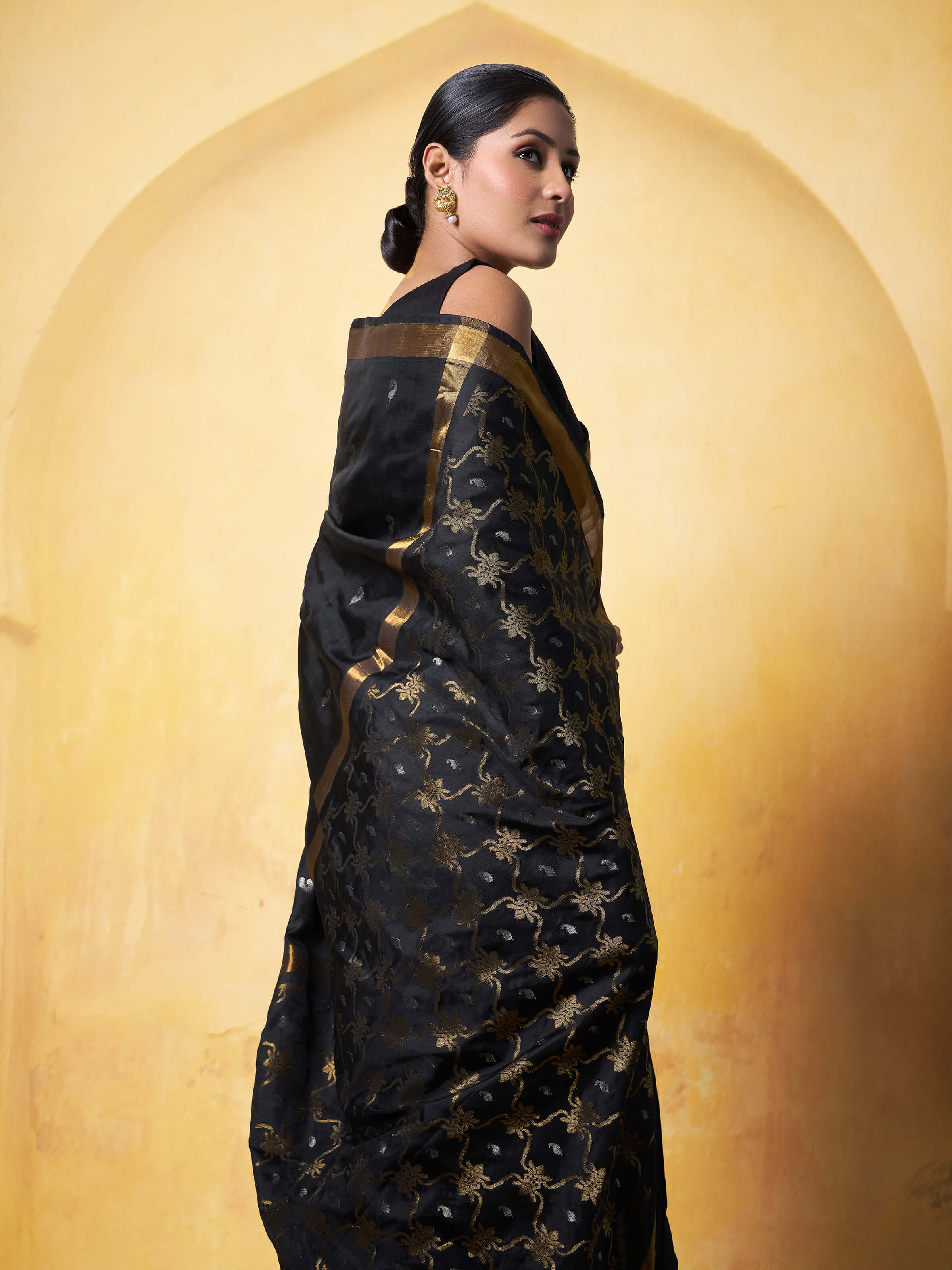 Angled view of black Uppada Jamdani saree showcasing pallu design and zari work