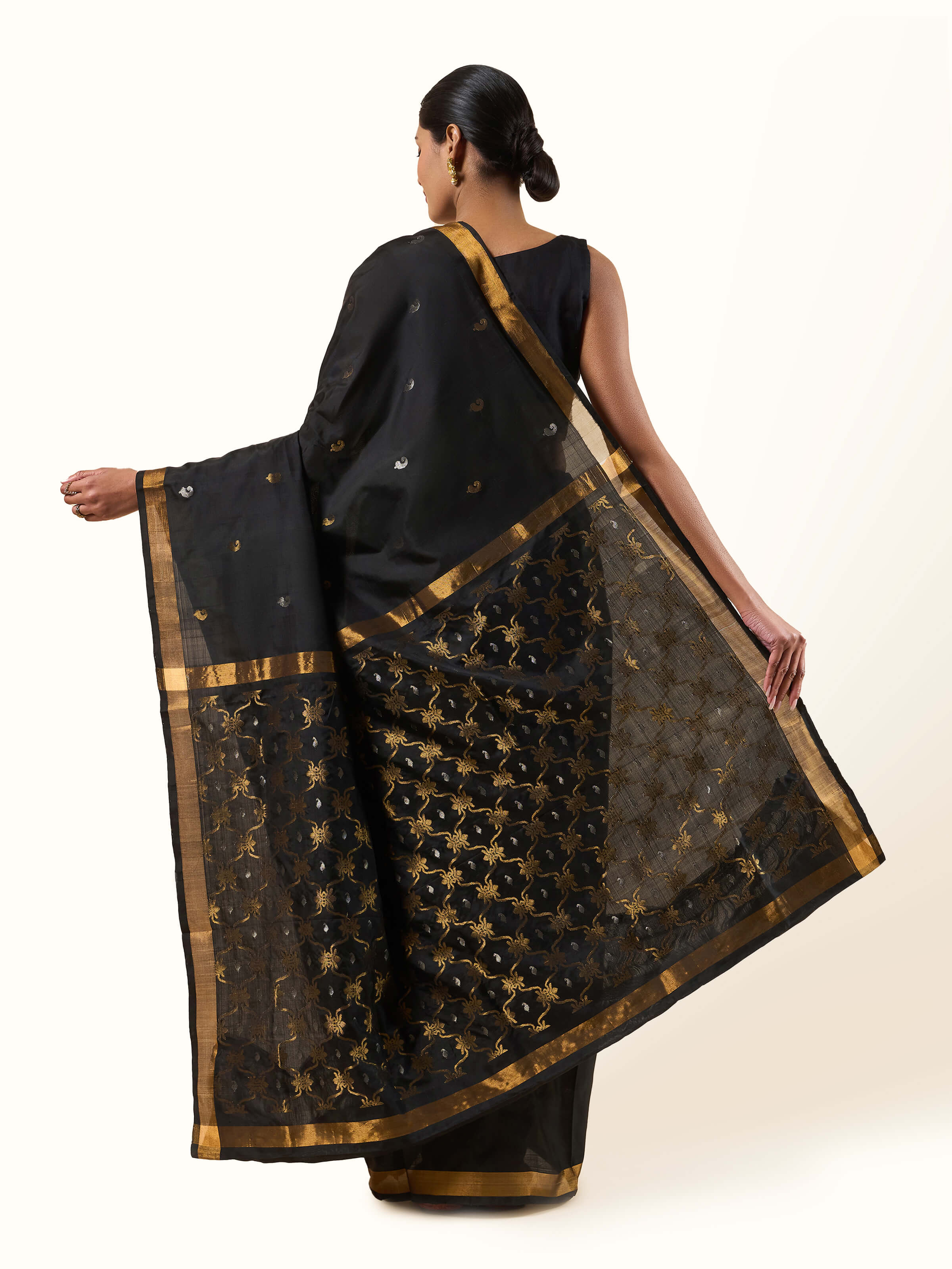 Back view of black Uppada Jamdani saree showing pleated drape and ornate pallu fall