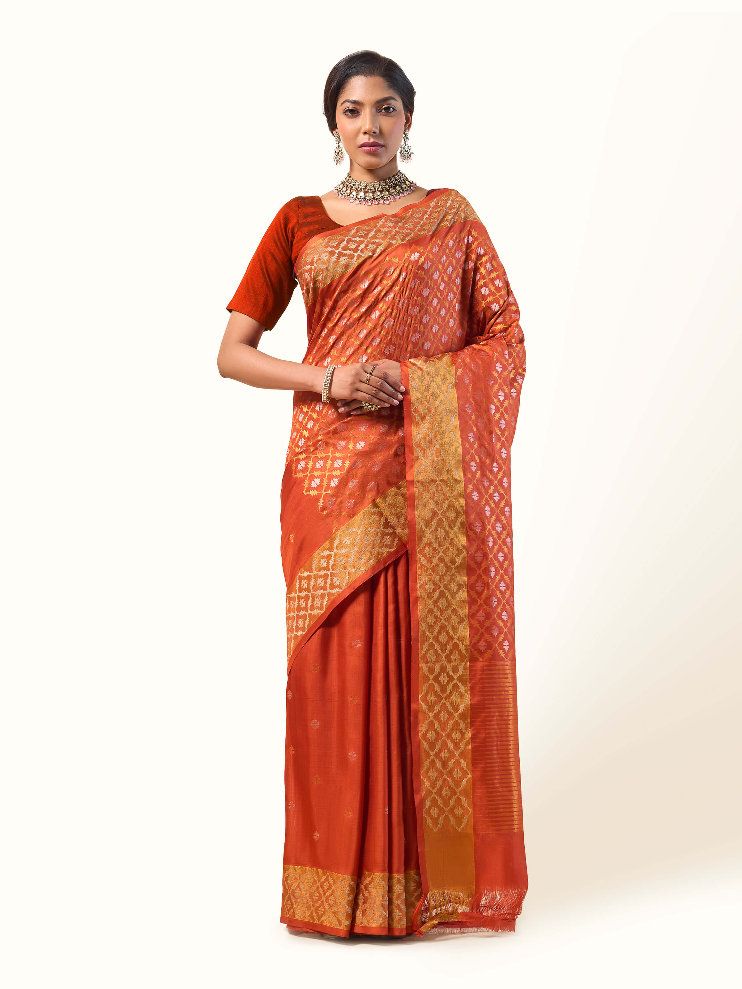 Front view of rust cotton silk Uppada Jamdani saree with zari detailing and broad border