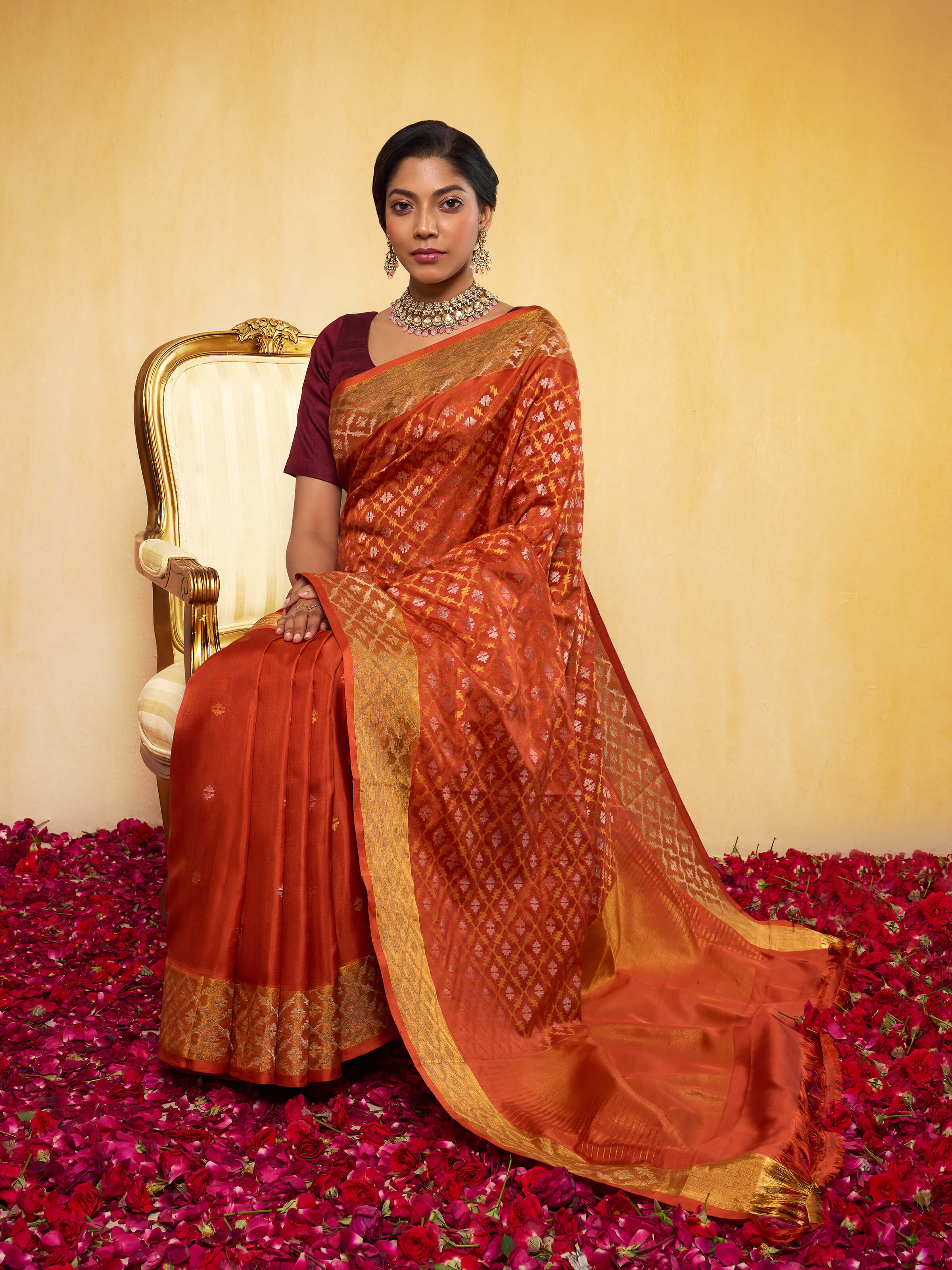 Lifestyle view of rust Uppada Jamdani saree draped elegantly with blouse
