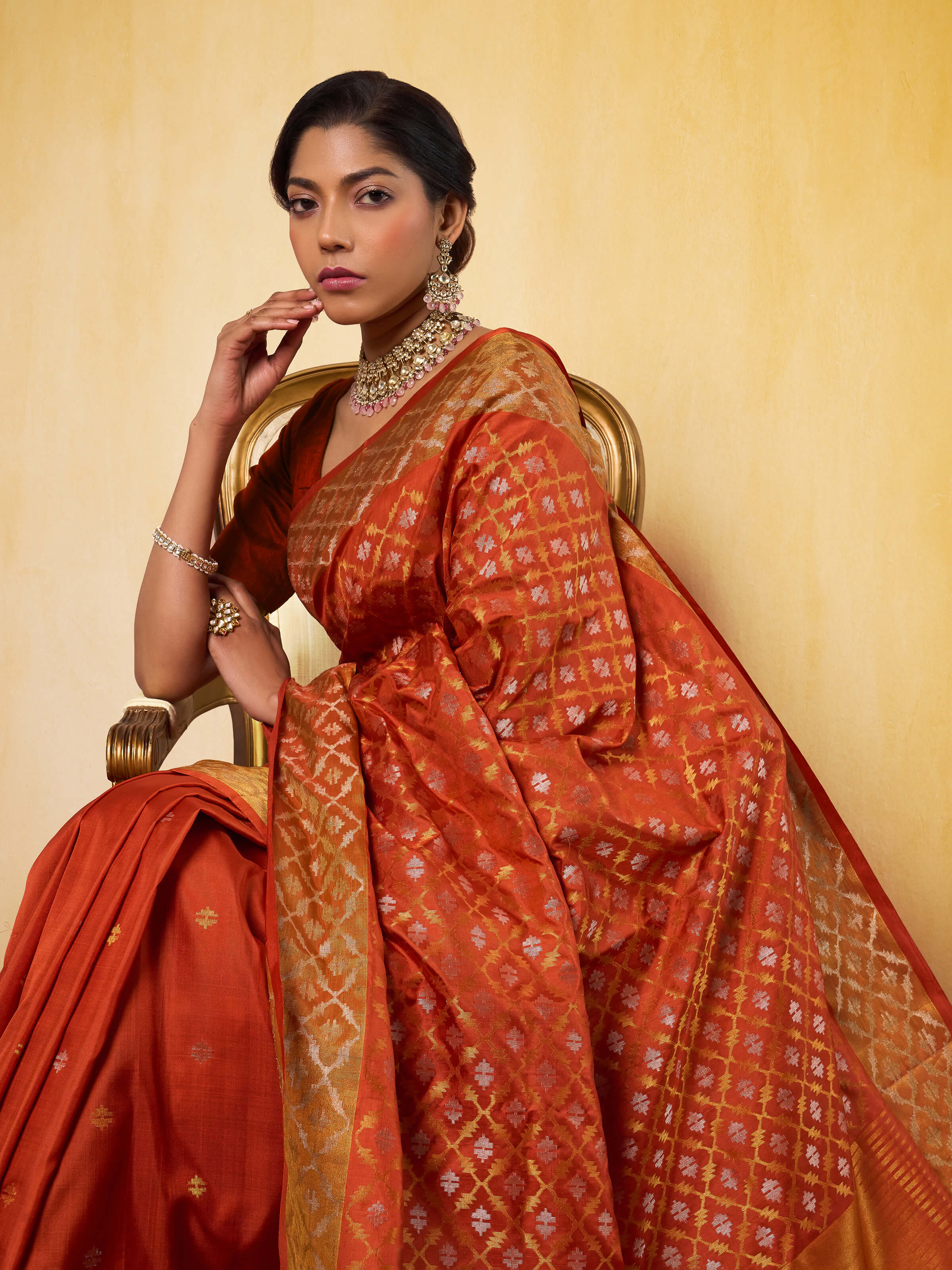 Angled view showing pallu and Jamdani weave on Uppada rust silk saree