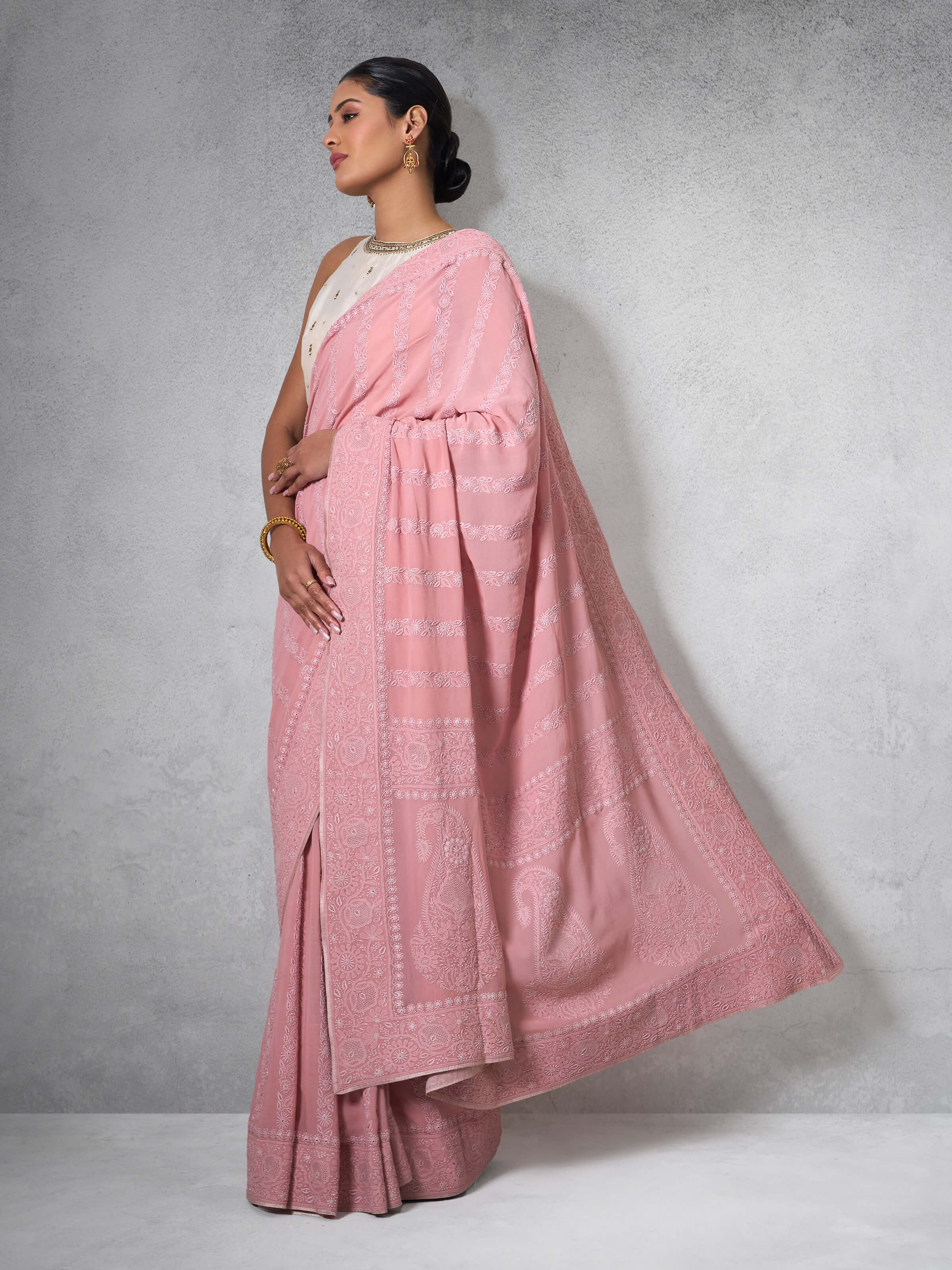 Angled view highlighting embroidery motifs and silk georgette texture.