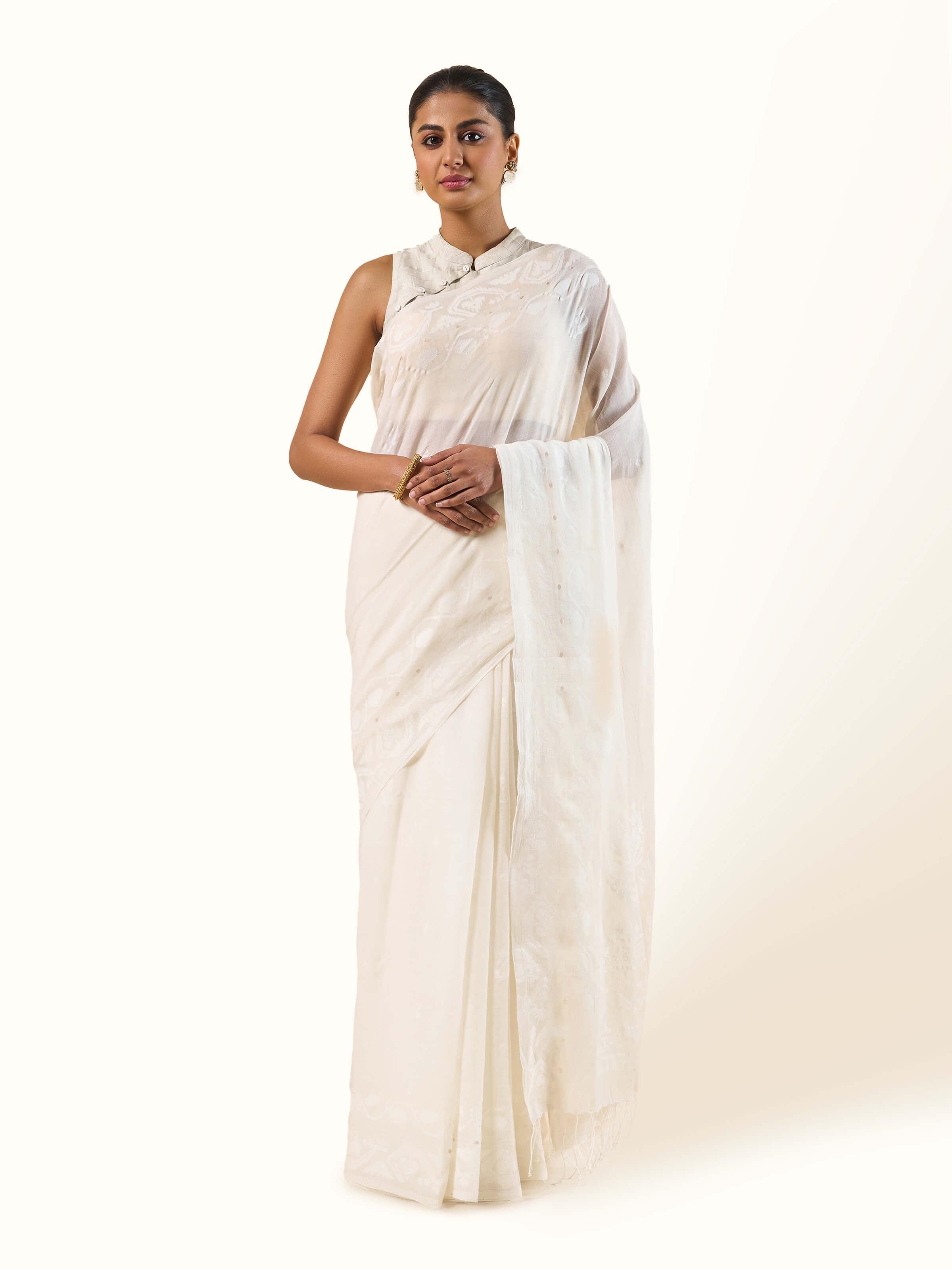 Front view of white Muslin Jamdani saree with intricate woven motifs.