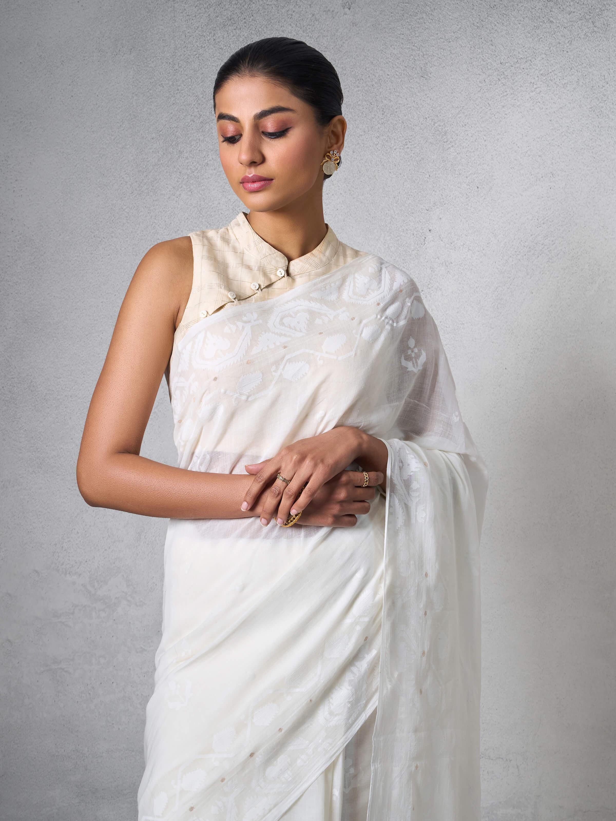 Detail shot showing fine muslin texture and handwoven floral motifs.