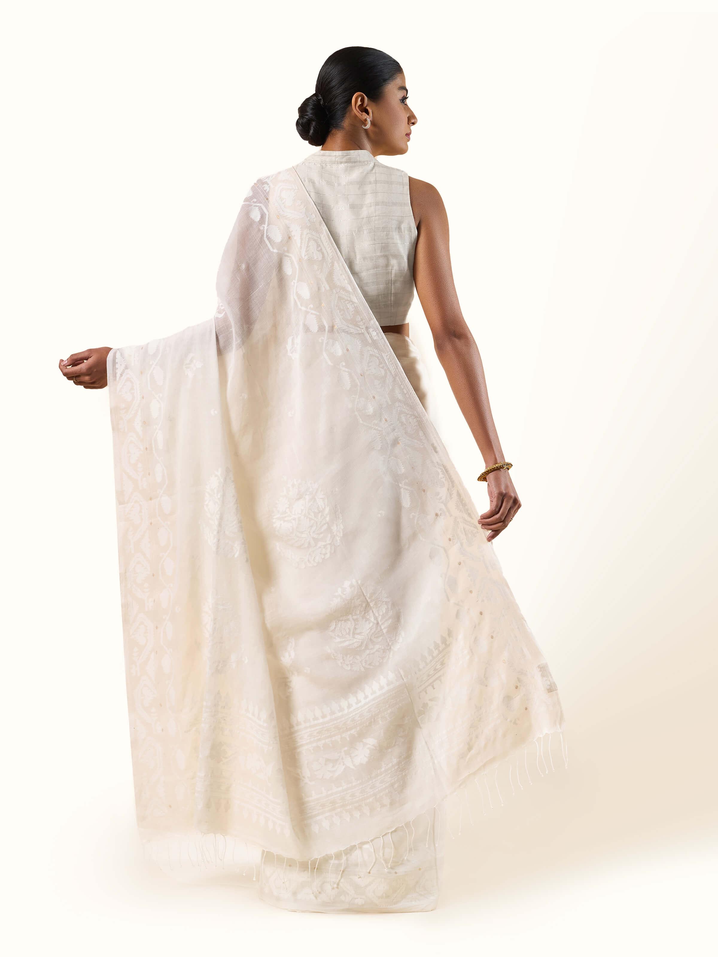 Back view highlighting pallu design and woven Jamdani patterns.