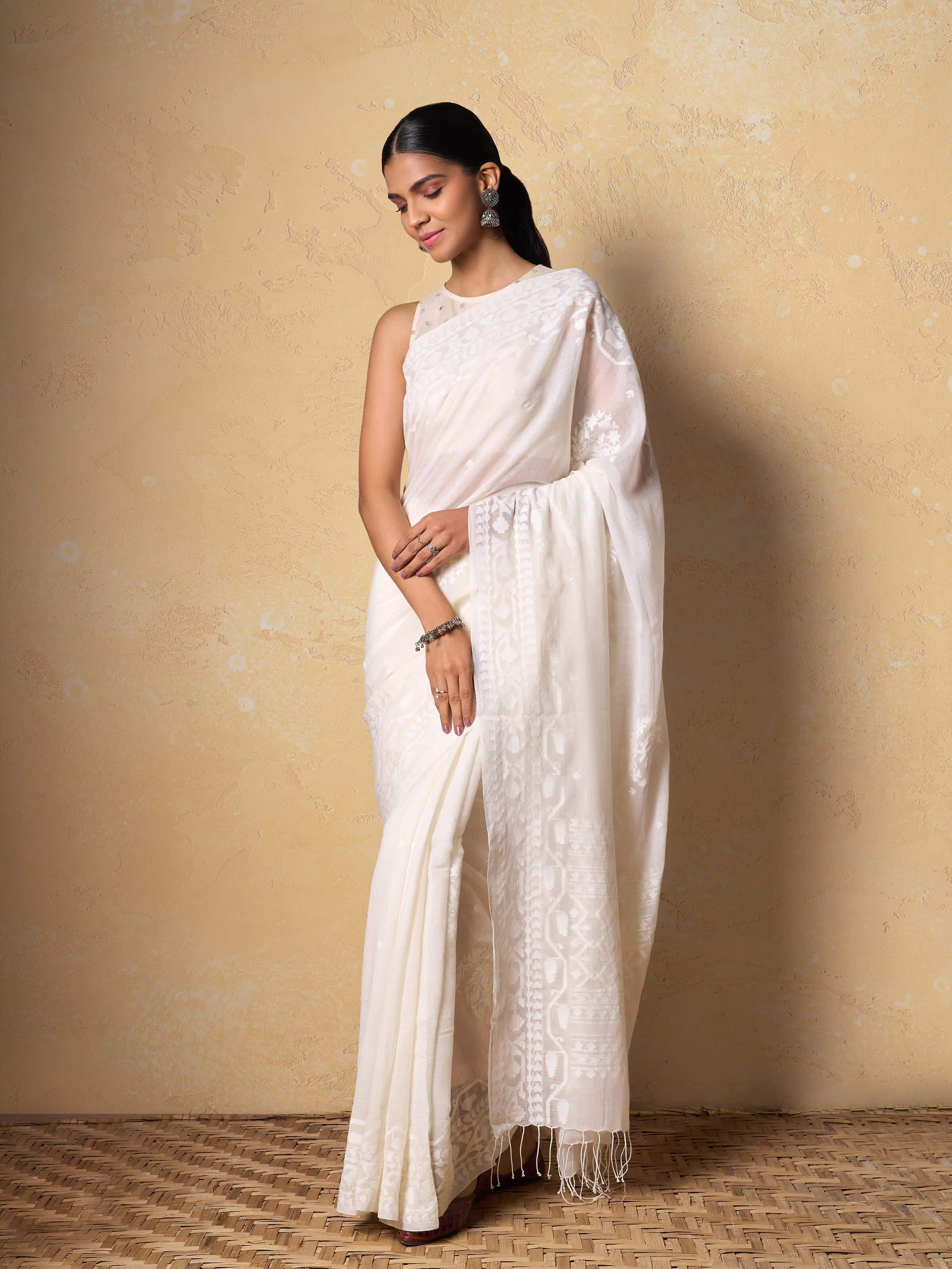 Lifestyle view of off-white Jamdani saree styled with minimalist accessories