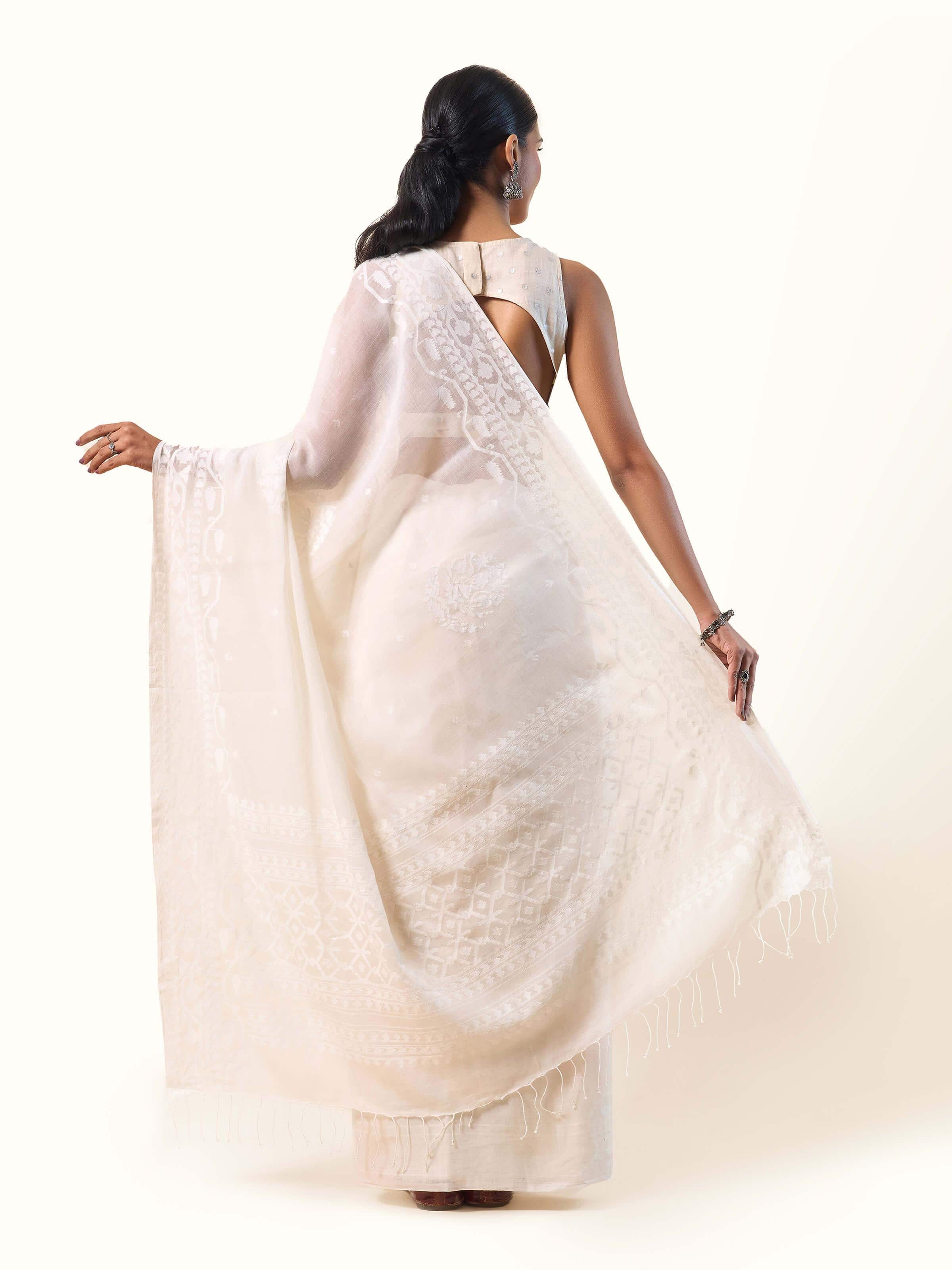 Back view of off-white Jamdani saree highlighting soft pleats