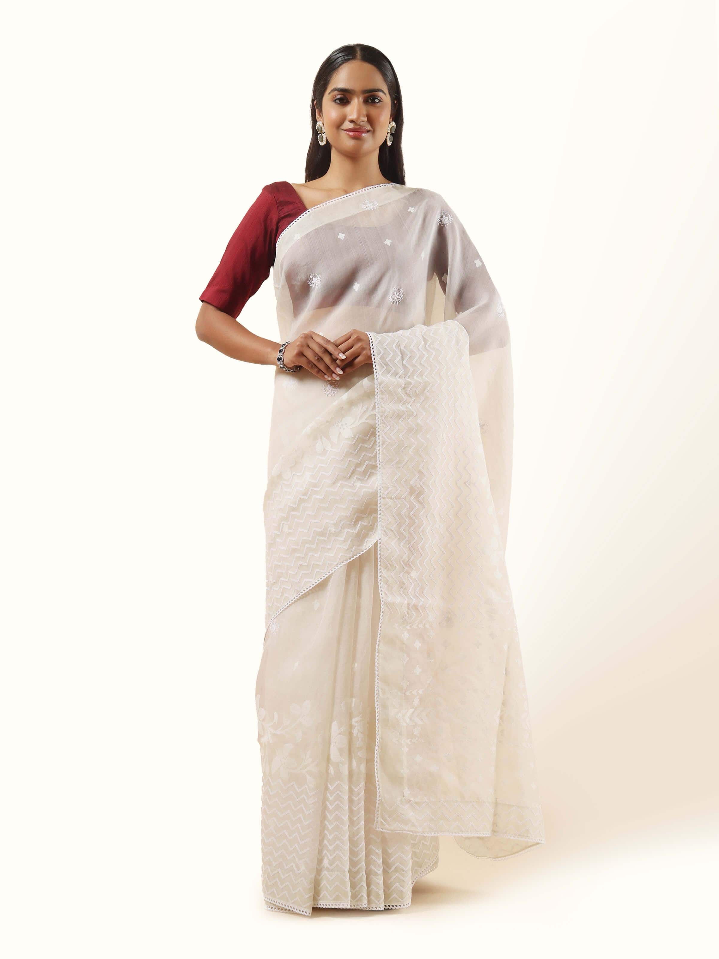 Front view of the off-white organza silk Jamdani saree, with delicate floral motifs floating across the sheer fabric.