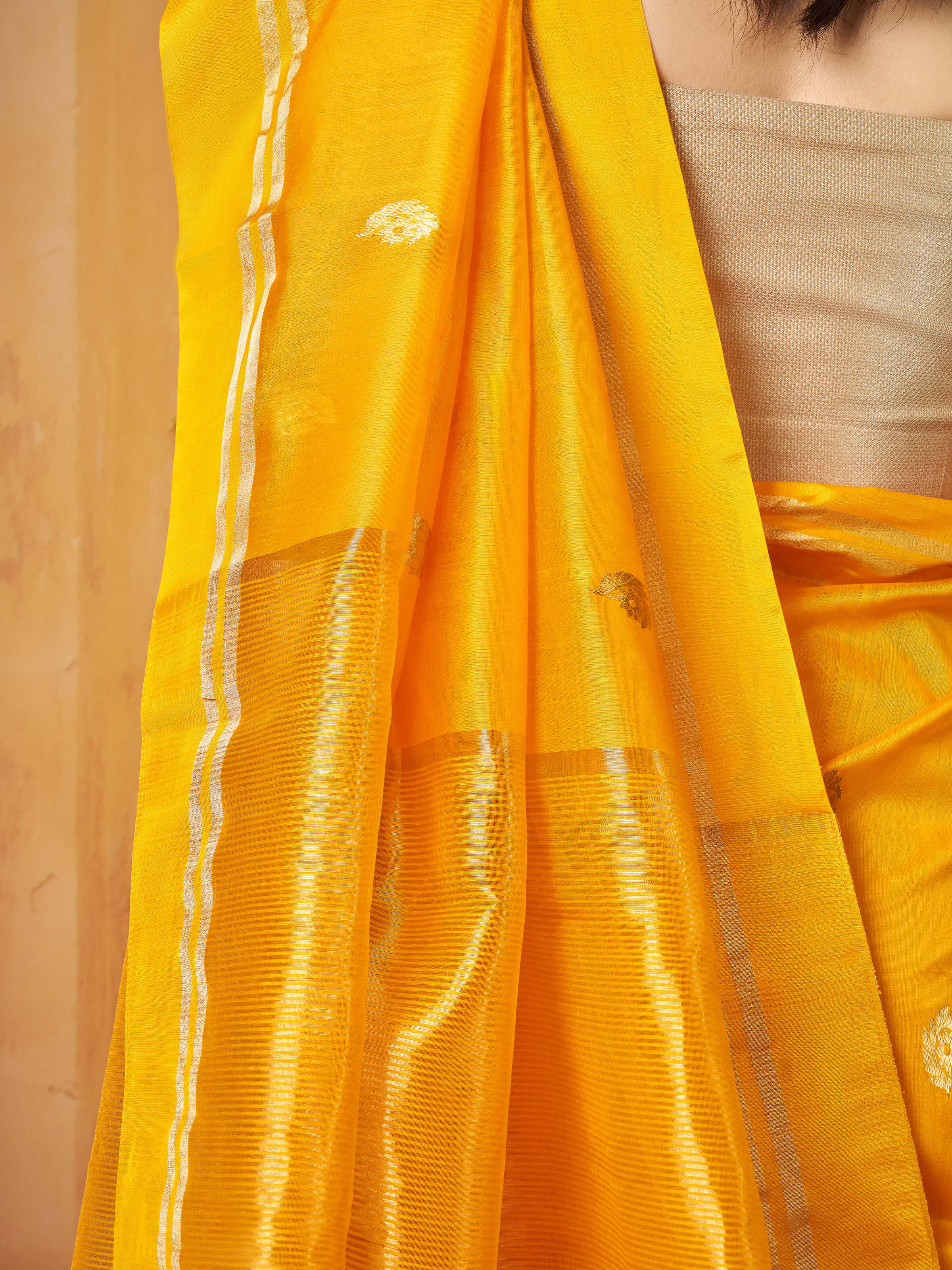 Detail shot of Chanderi saree fabric highlighting fine weave and subtle gold accents