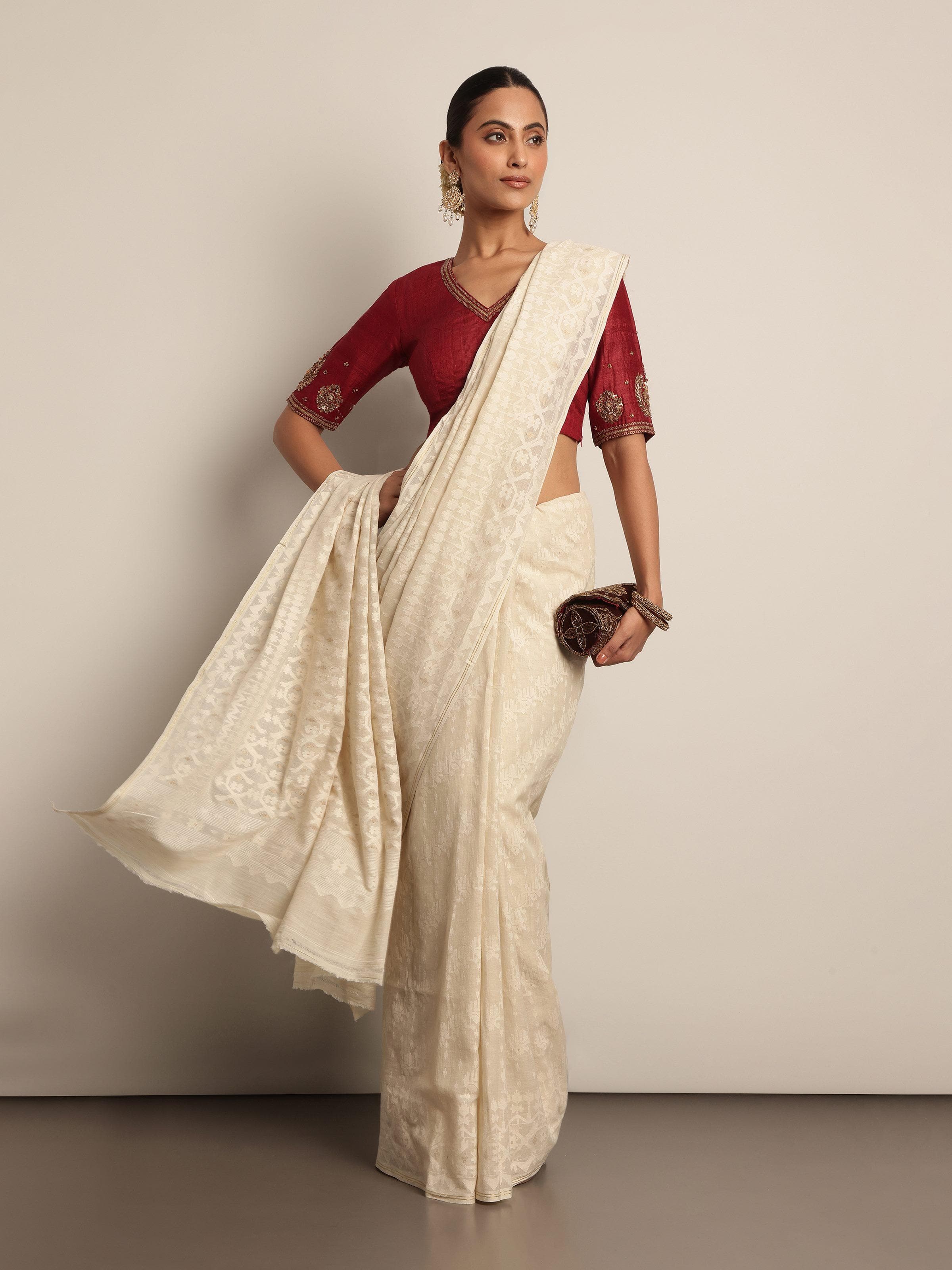 Off-white muslin cotton Jamdani saree lifestyle view draped gracefully showcasing pattern and soft fall