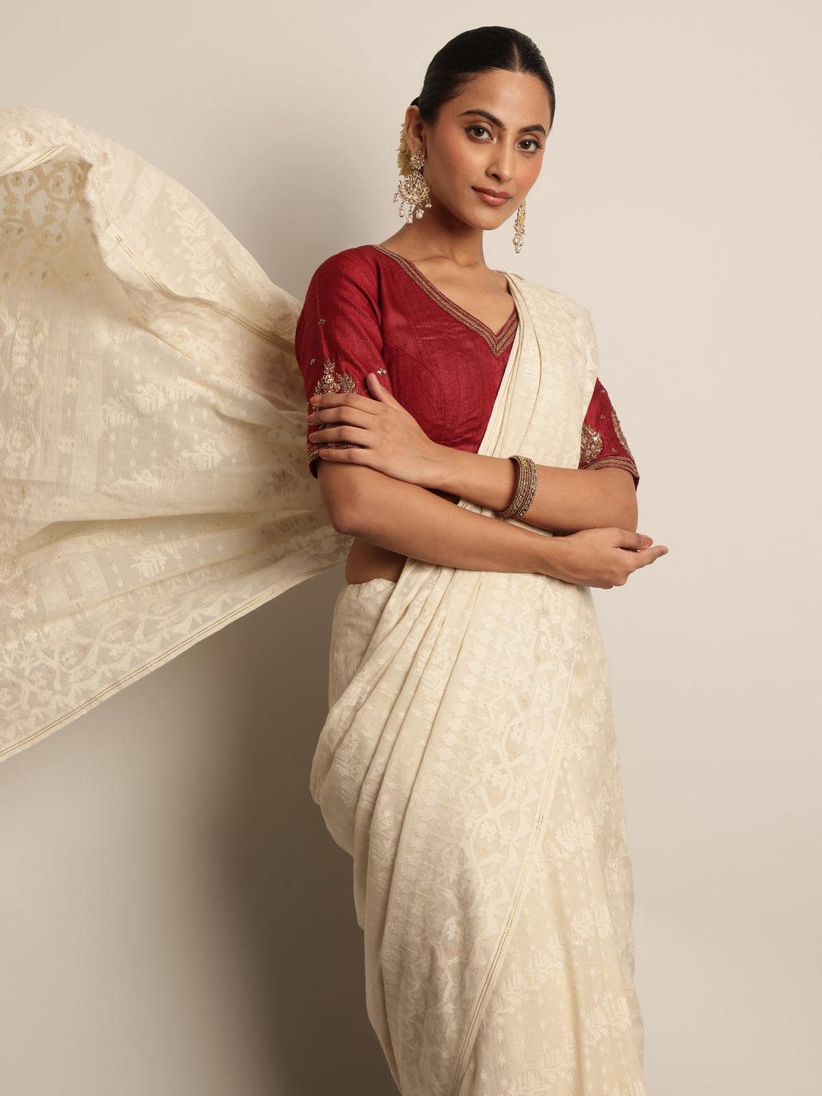 Off-white muslin cotton Jamdani saree alternate lifestyle view with model highlighting transparency and flow