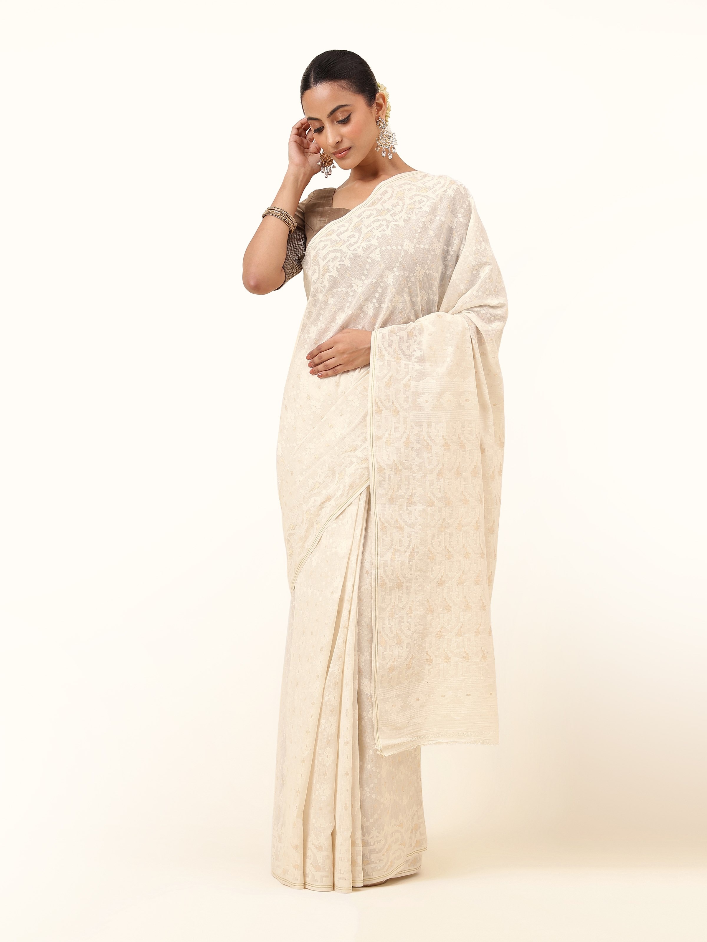 Front view of white muslin Jamdani saree featuring delicate floral motifs.