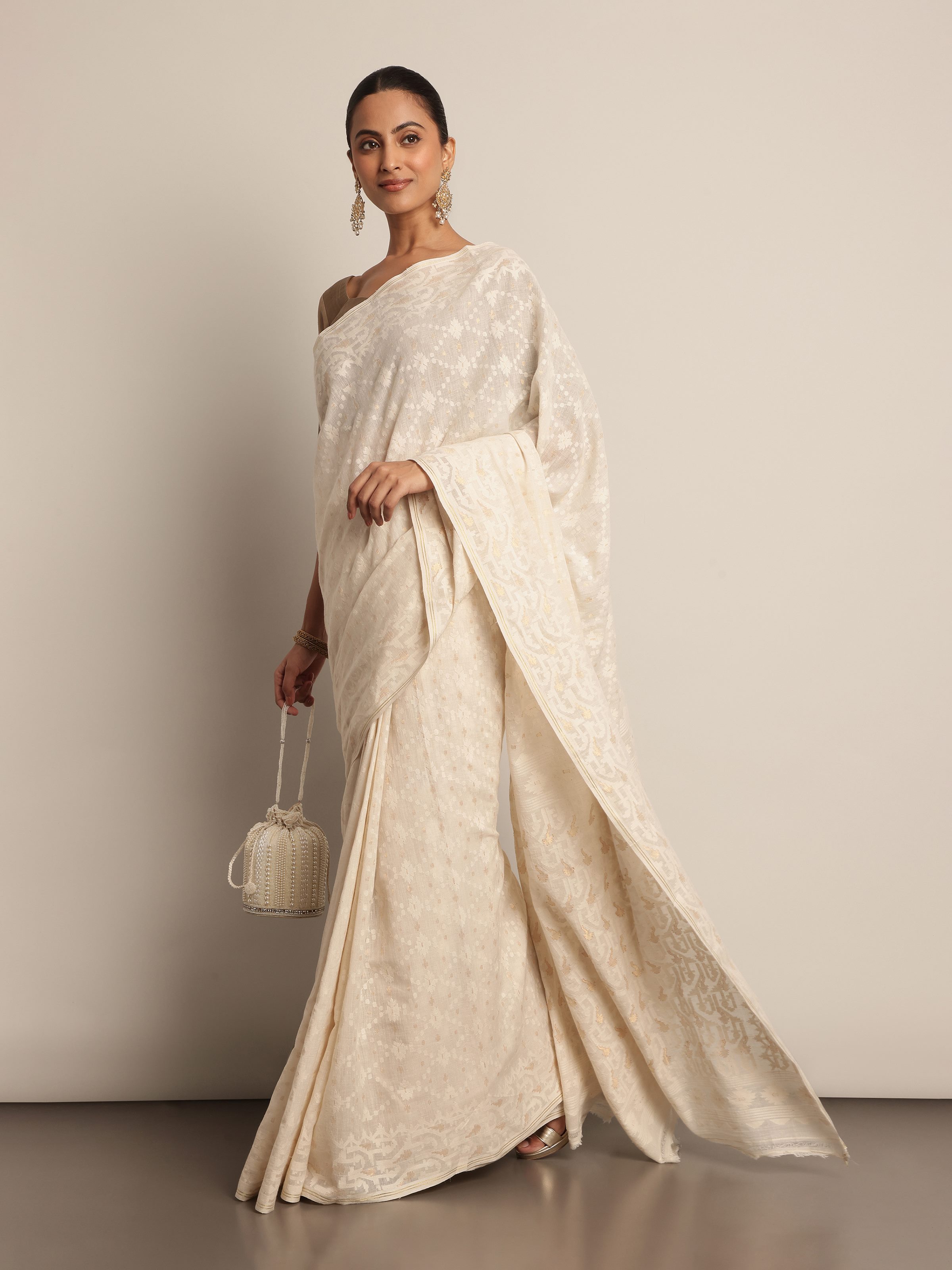 Lifestyle view of muslin cotton Jamdani saree styled traditionally.