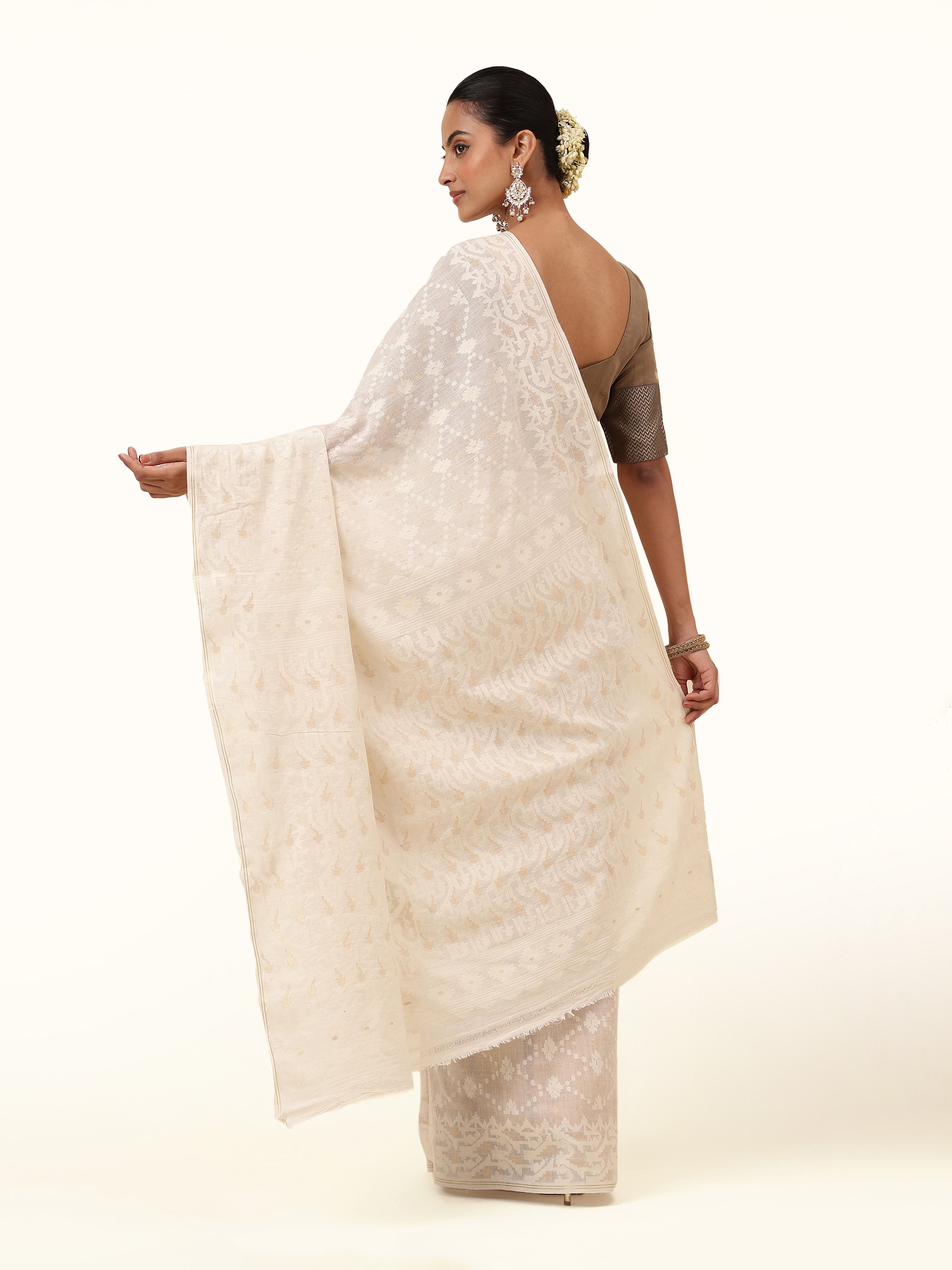 Back view of muslin Jamdani saree showcasing intricate jamdani motifs.