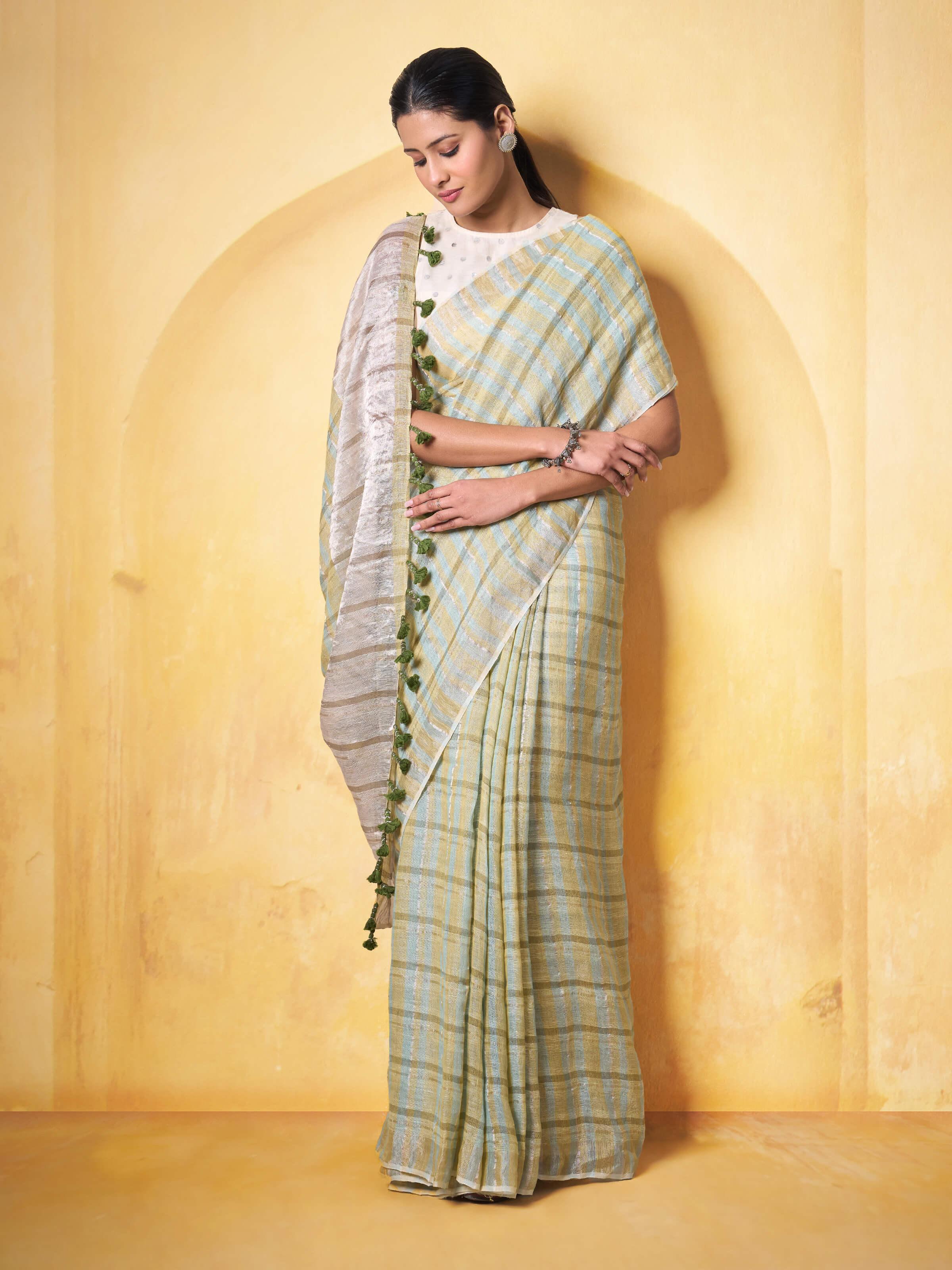Lifestyle shot of model draped in Light Olive Linen Saree showcasing fabric flow and sheen