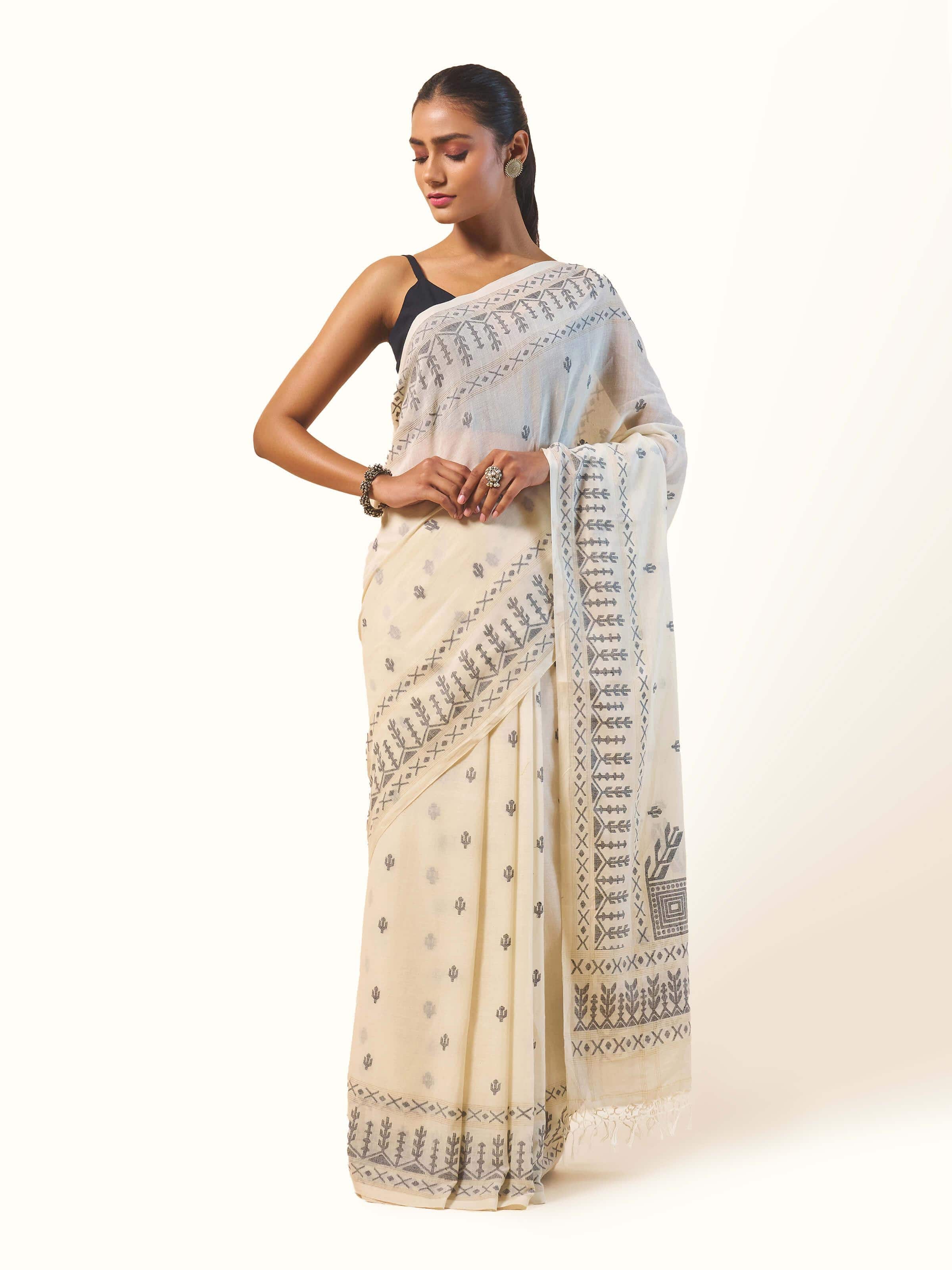 Front view of off-white cotton Jamdani saree showcasing traditional woven motifs.