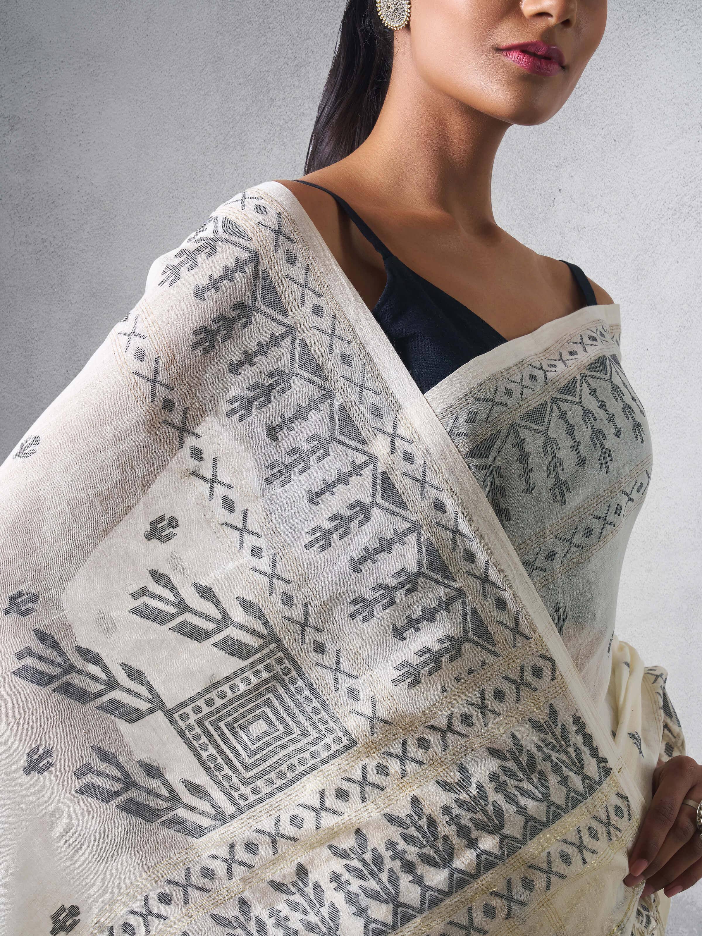 Detail shot of off-white cotton Jamdani saree revealing fine Jamdani weave.