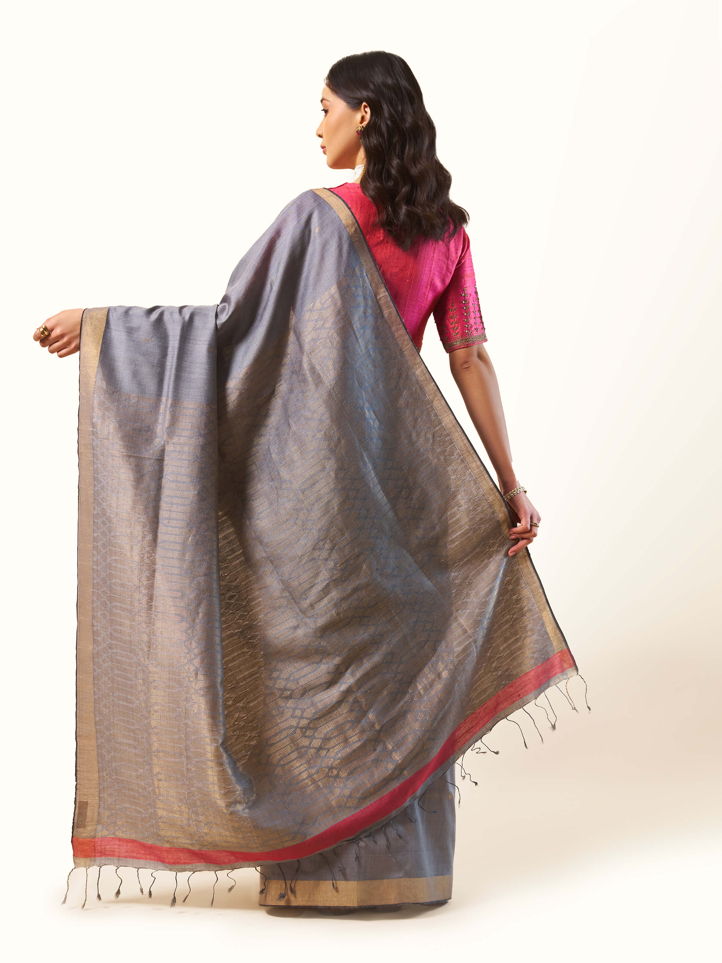 Back view capturing the subtle elegance and flow of the saree’s design.