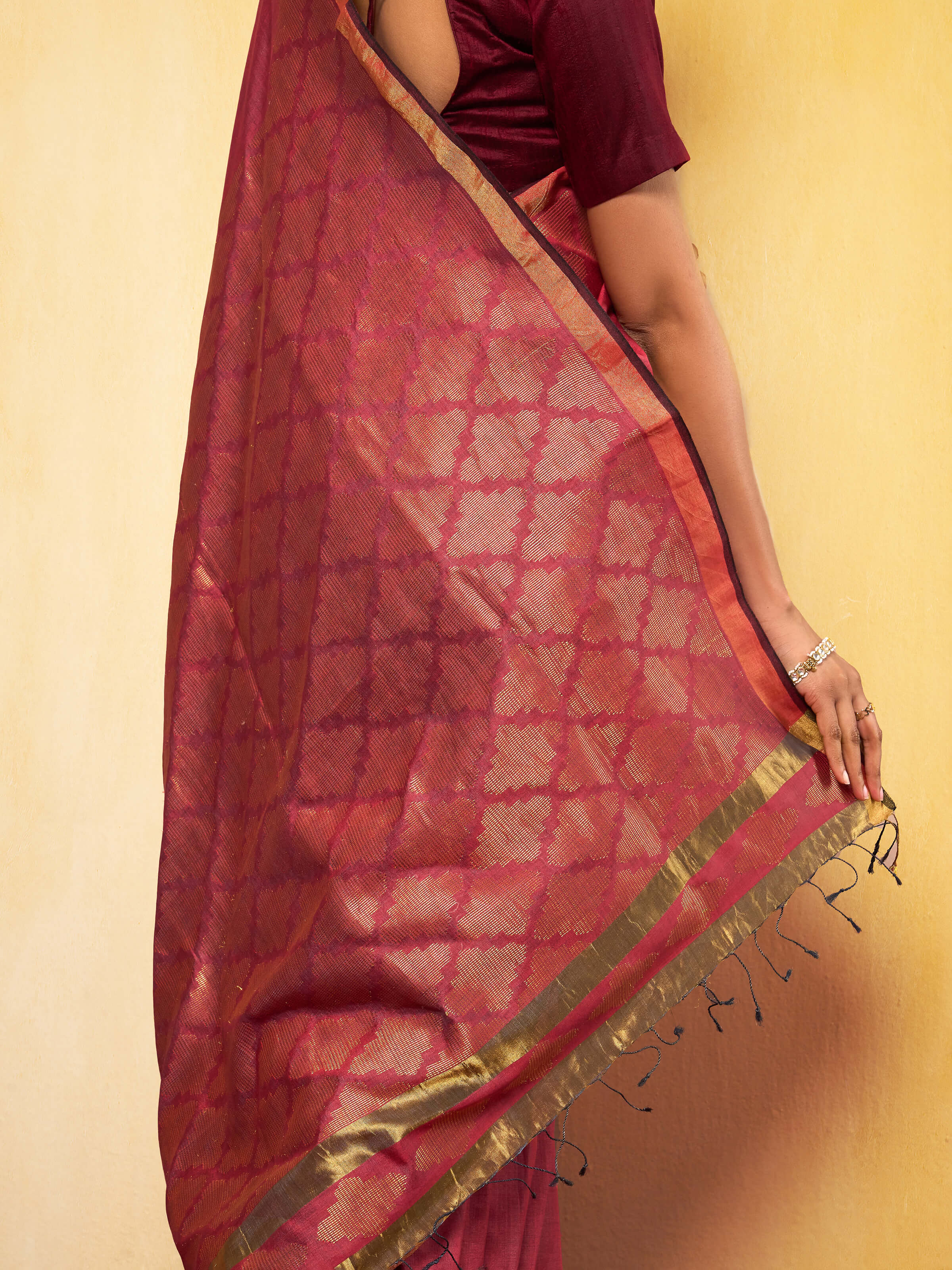 Detailed shot of Maroon Eri Silk Extra-weft Saree pallu highlighting intricate patterns.