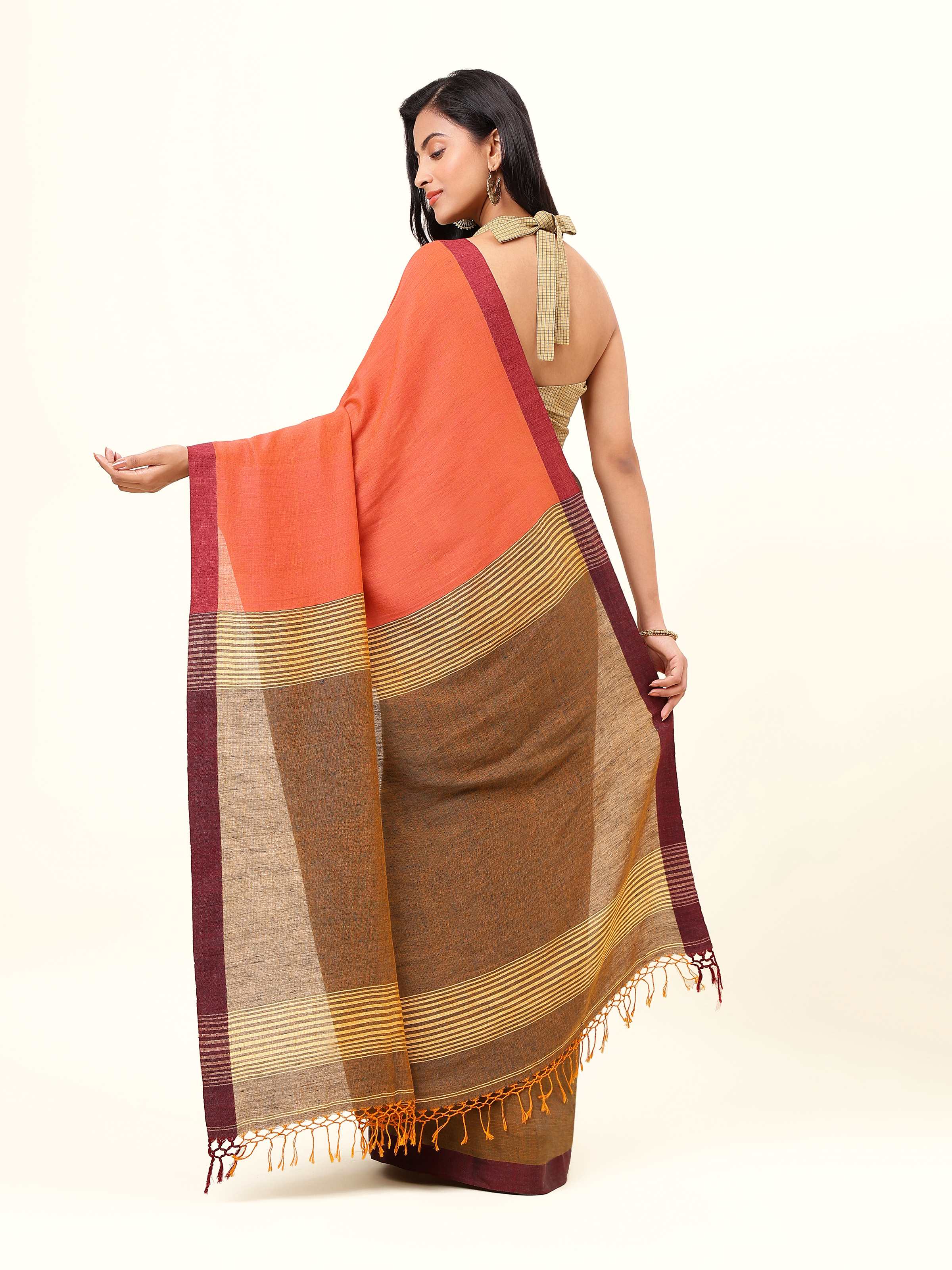 Back view of grey linen saree displaying straight pallu and elegant fall.