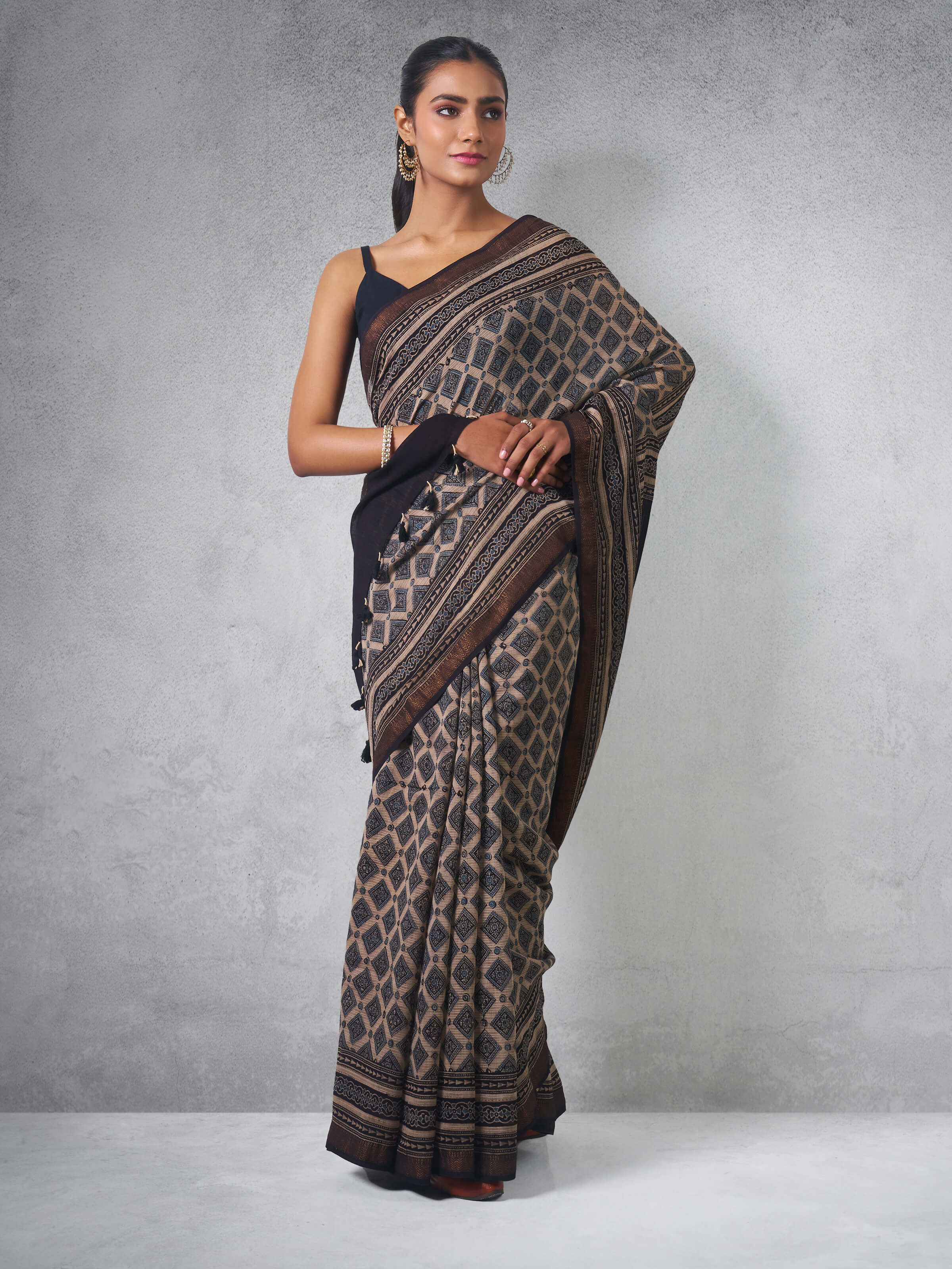 Lifestyle view of Maheshwari Ajrakh saree styled with silver jewelry and contemporary blouse