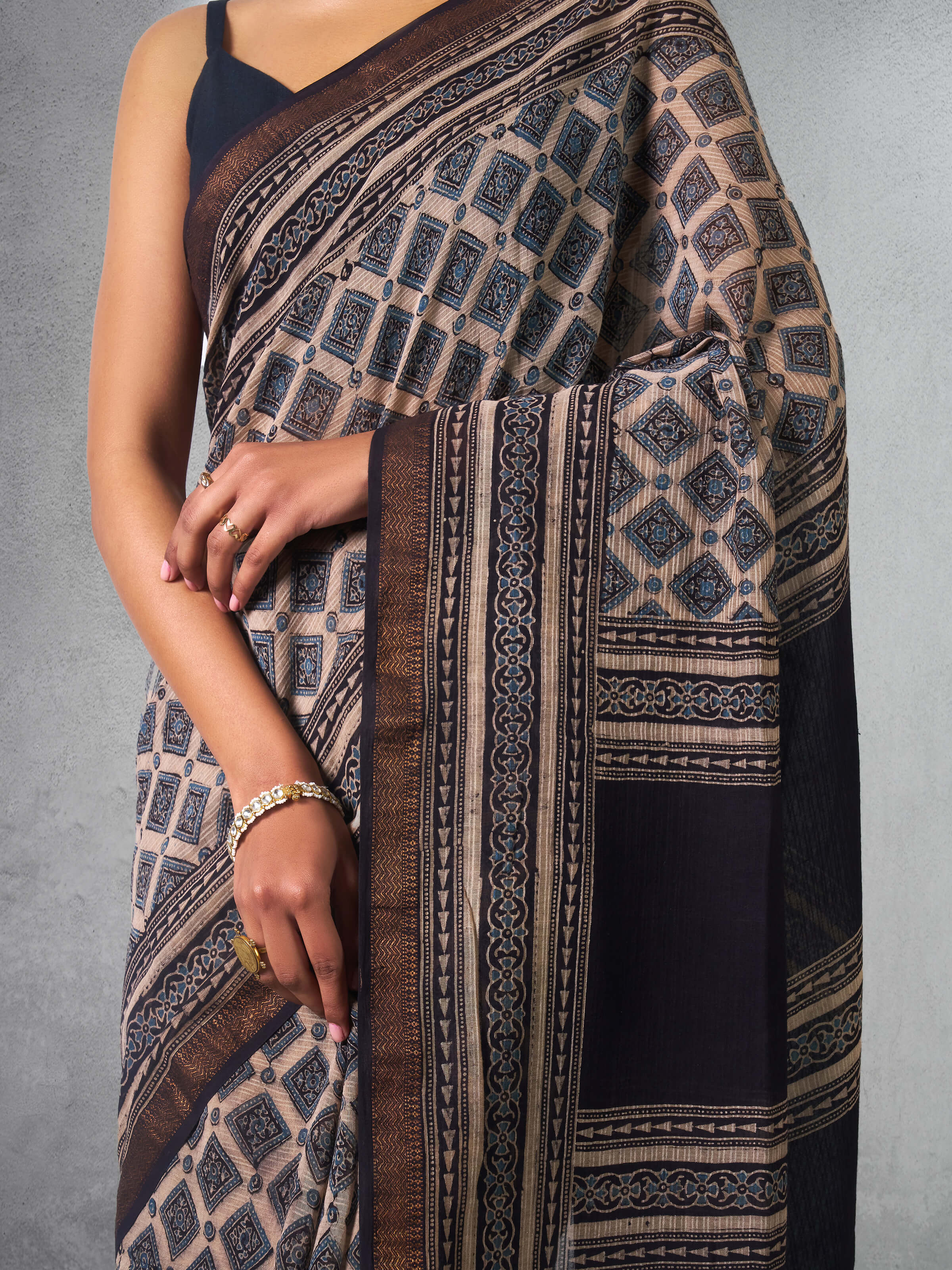 Detail shot of Maheshwari Ajrakh saree focusing on border print and traditional motifs