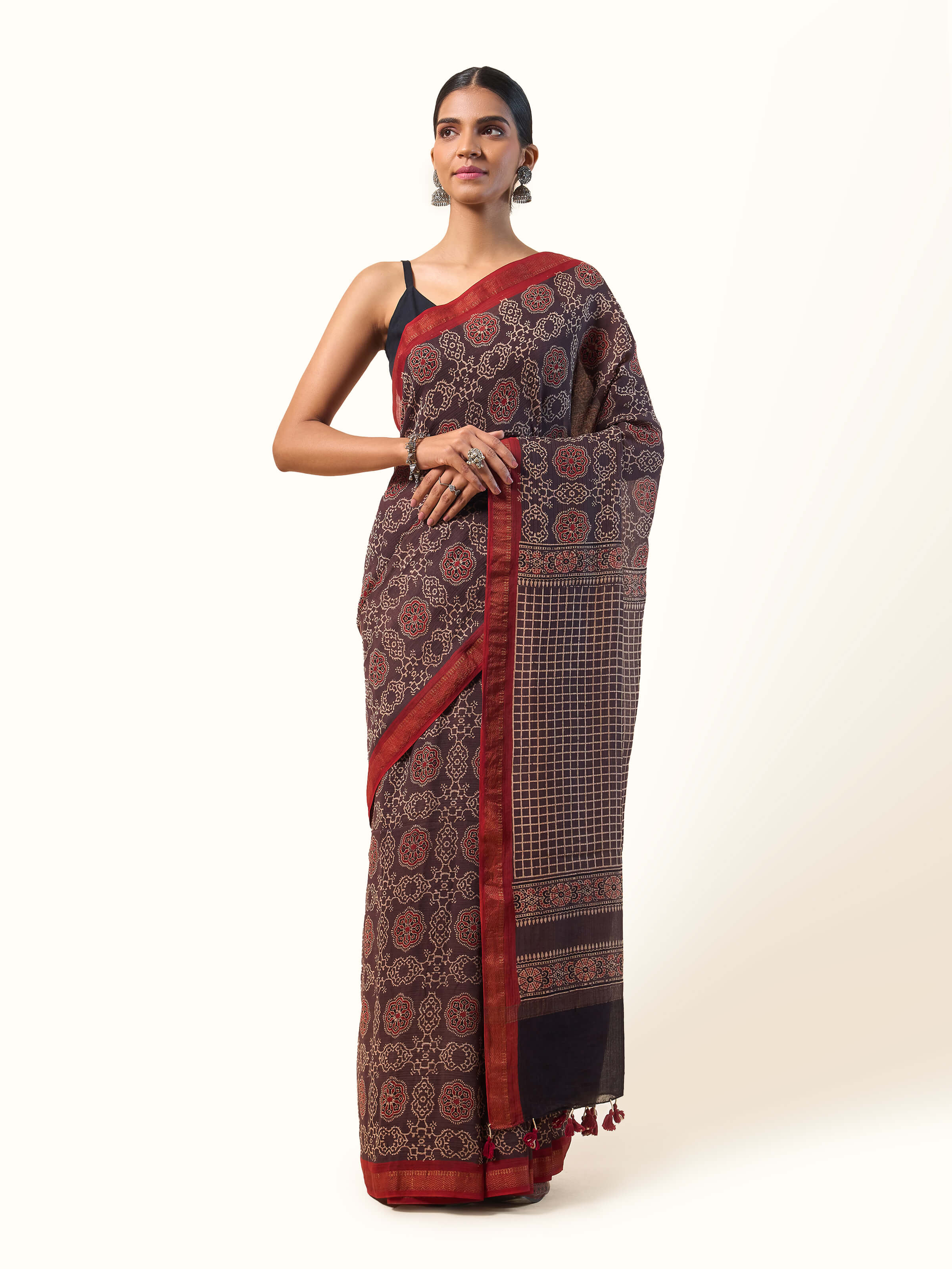 Front view of maroon Maheshwari saree with Ajrakh block print and zari pallu